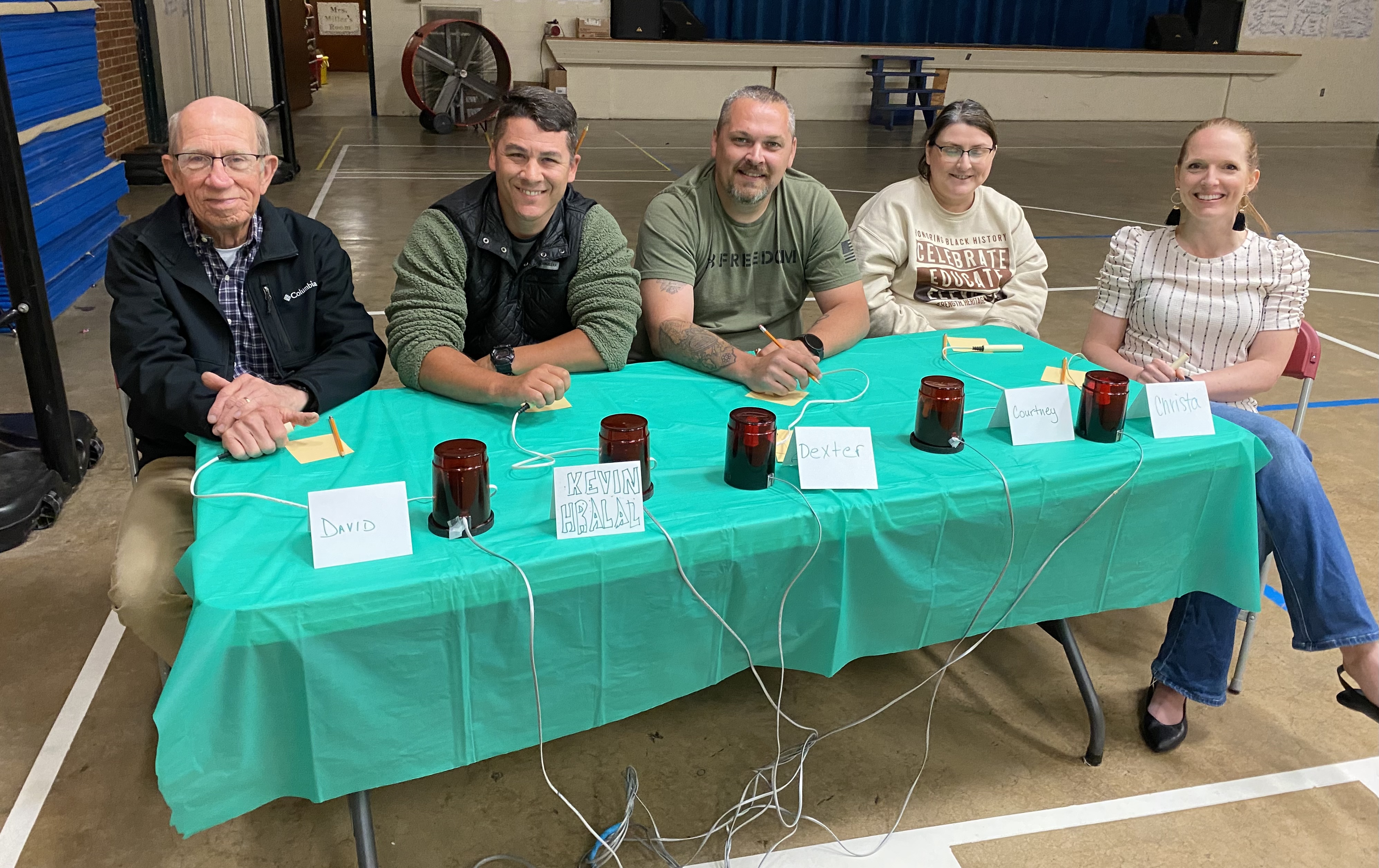 parents smiling behind table