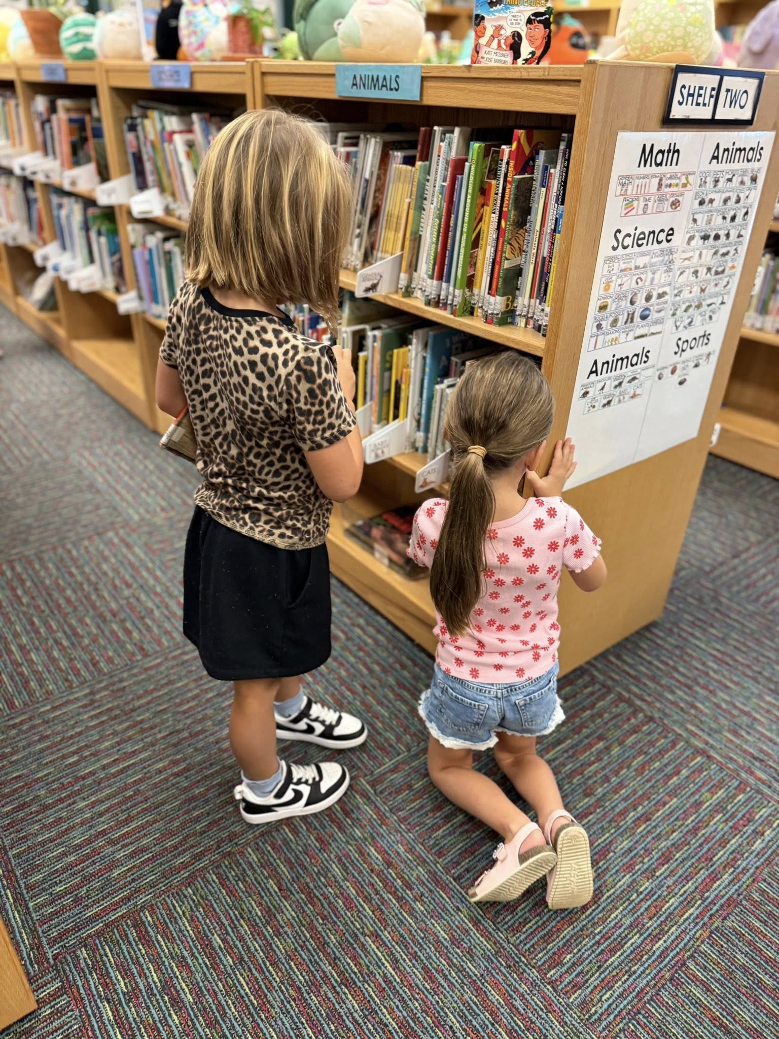 Students at library book shelf