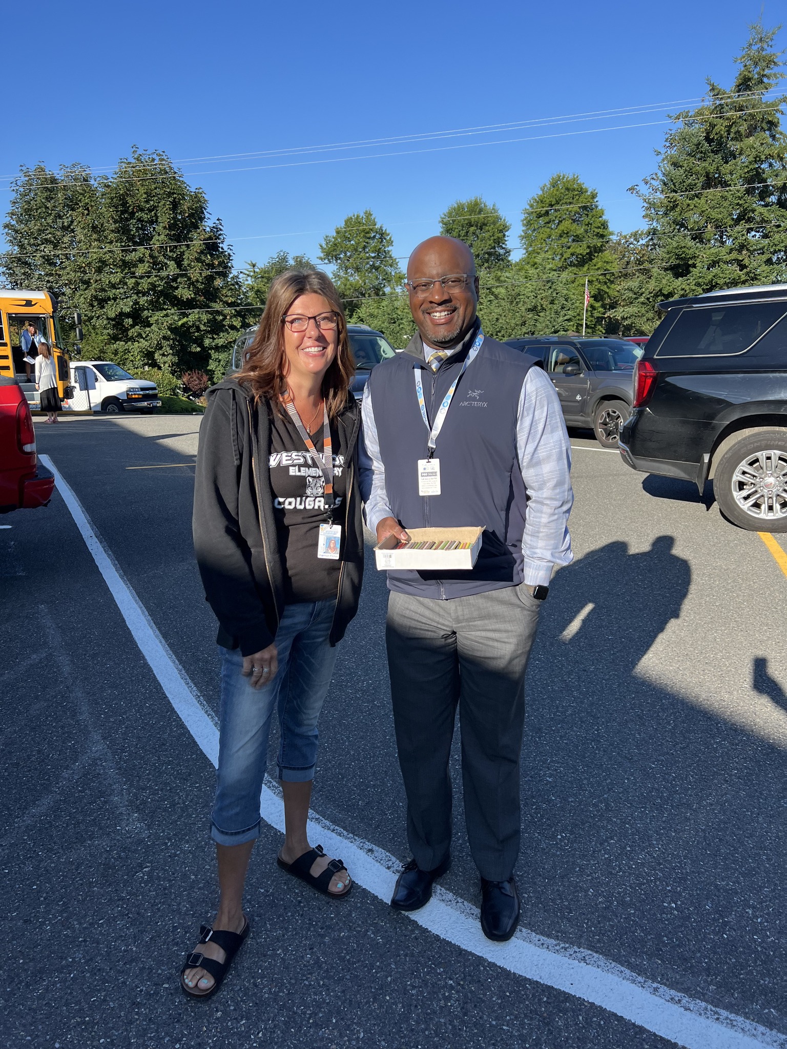 Superintendent Dr. Carey handing out first day pencils with Enumclaw Rotary