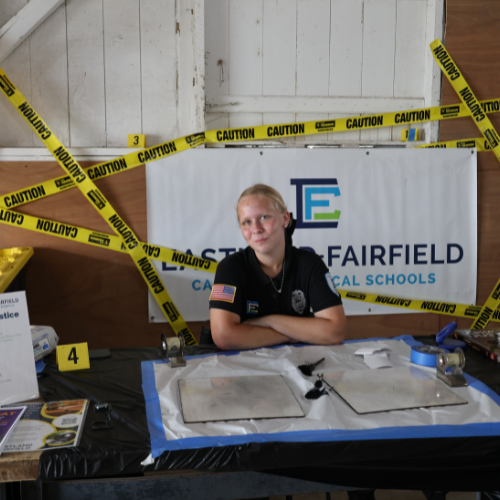 EFCTS Criminal Justice student at Eastland-Fairfield's booth at the Fairfield County Fair