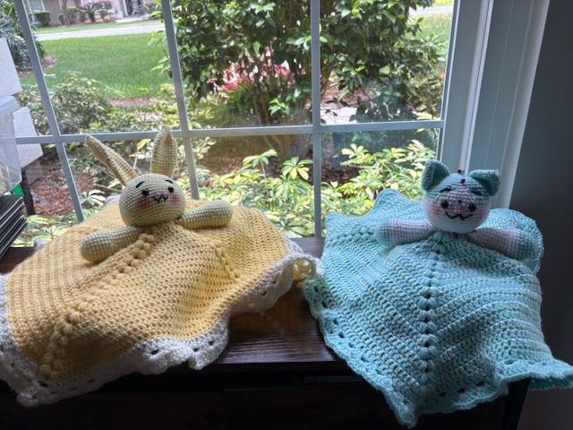 baby blankets with heads and arms; yellow bunny and blue cat