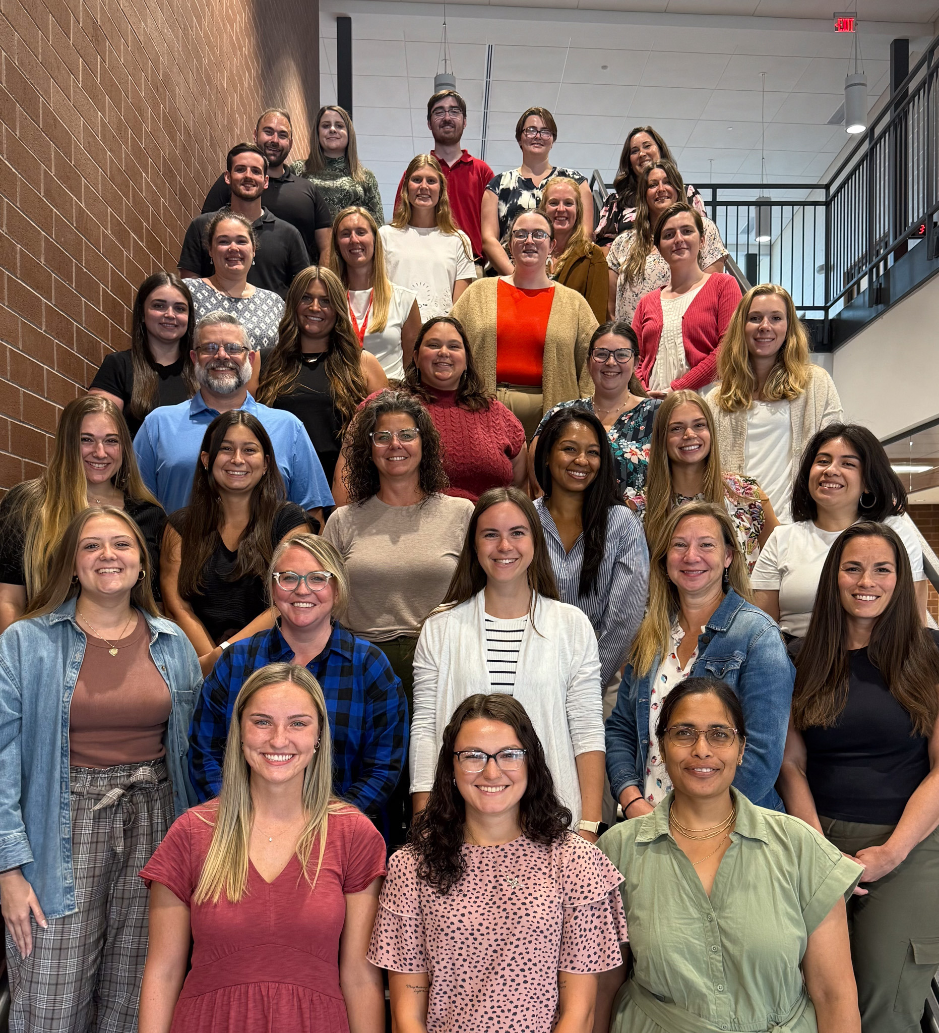Group photo of new CV educators for the 2025–2026 school year on an indoor staircase at Mountain View Middle School.