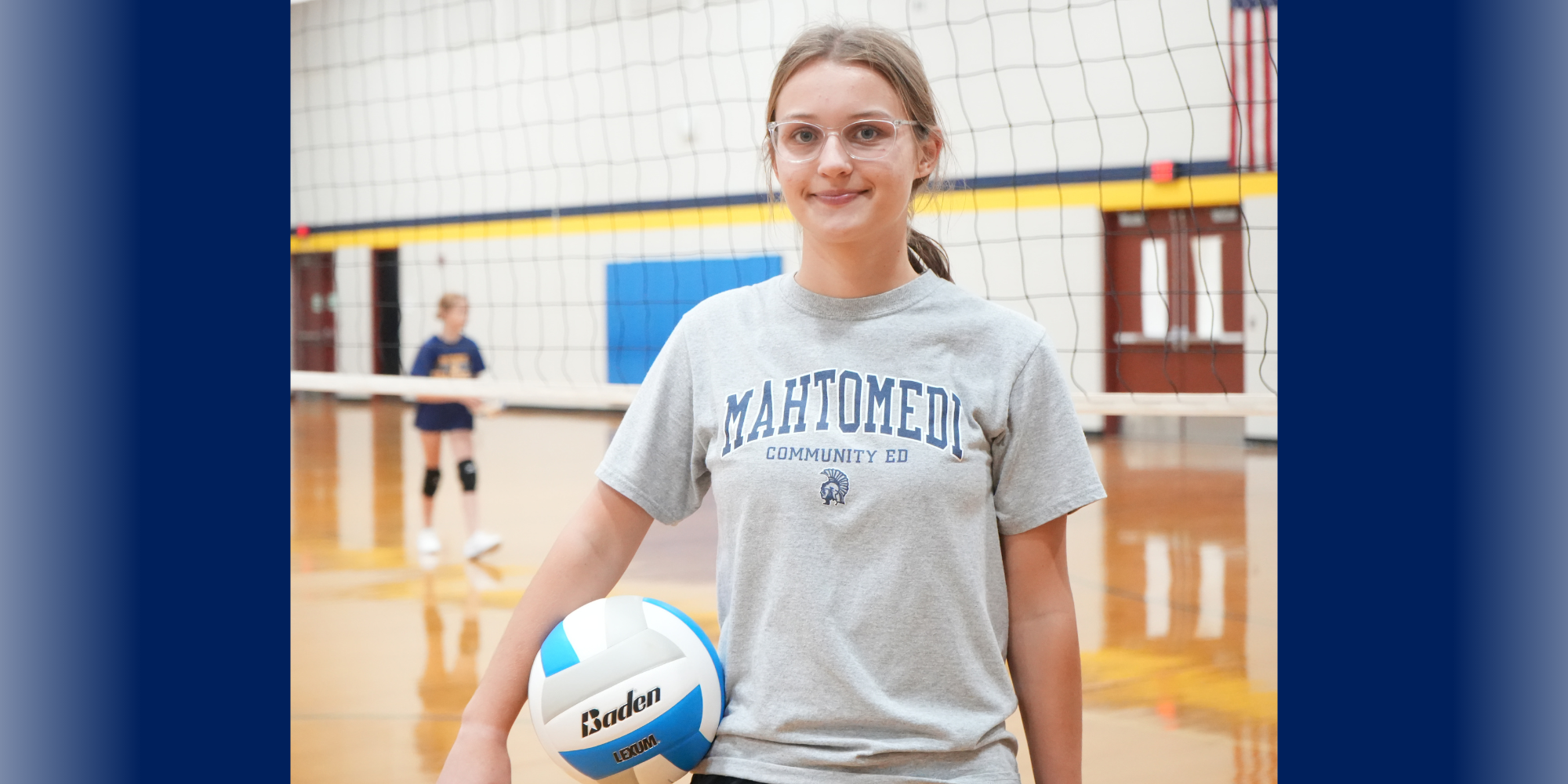 Josie Schifsky standing in gym with volleyball