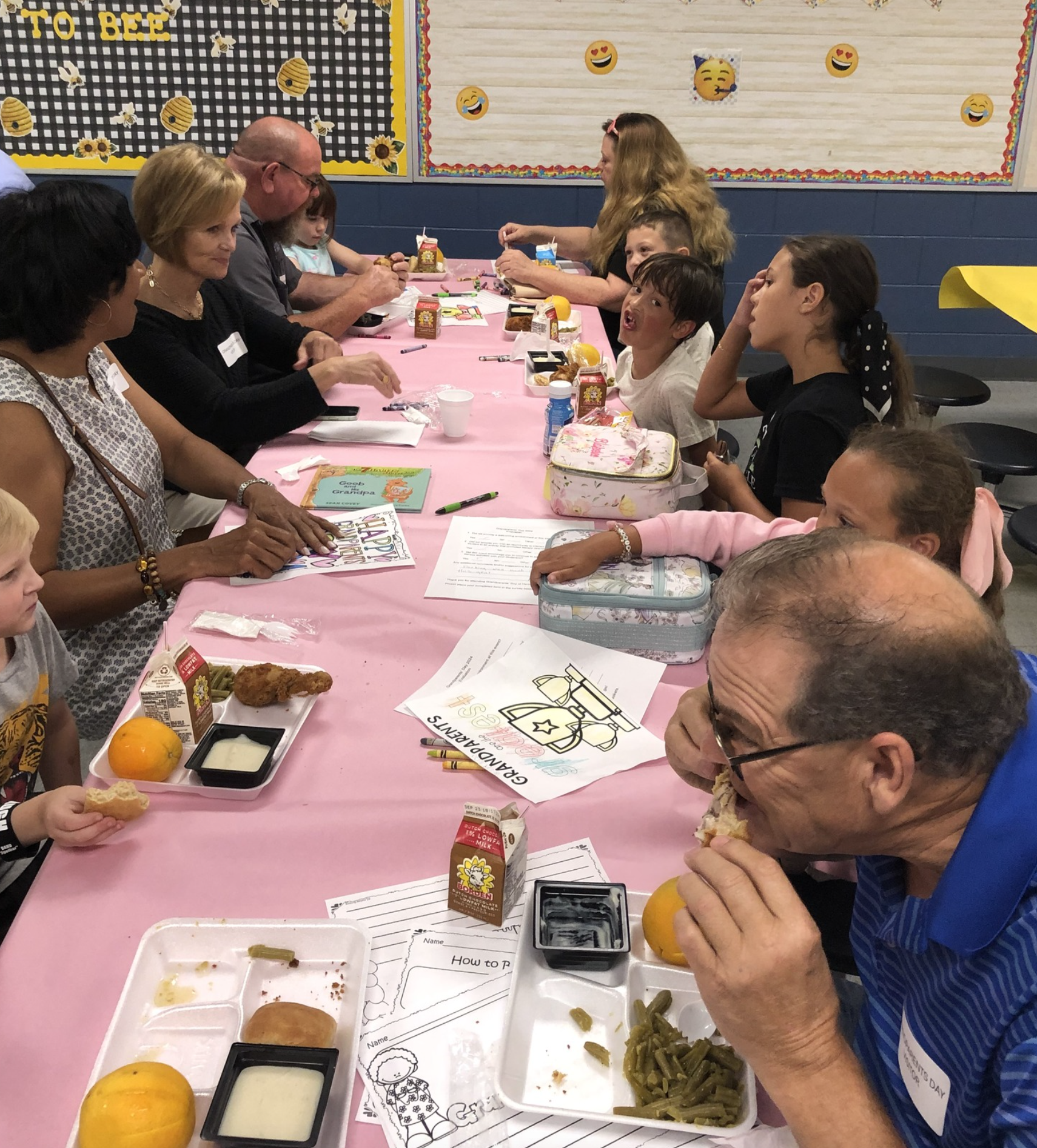 people at a pink table eating