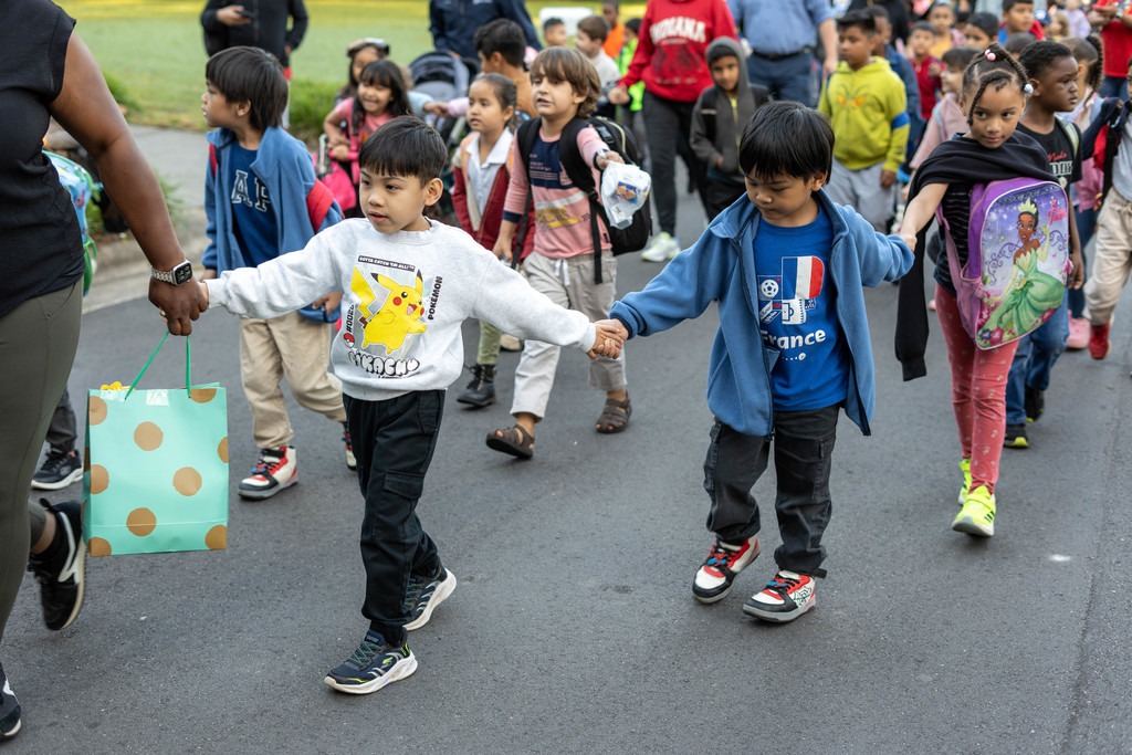 children walking while holding hands