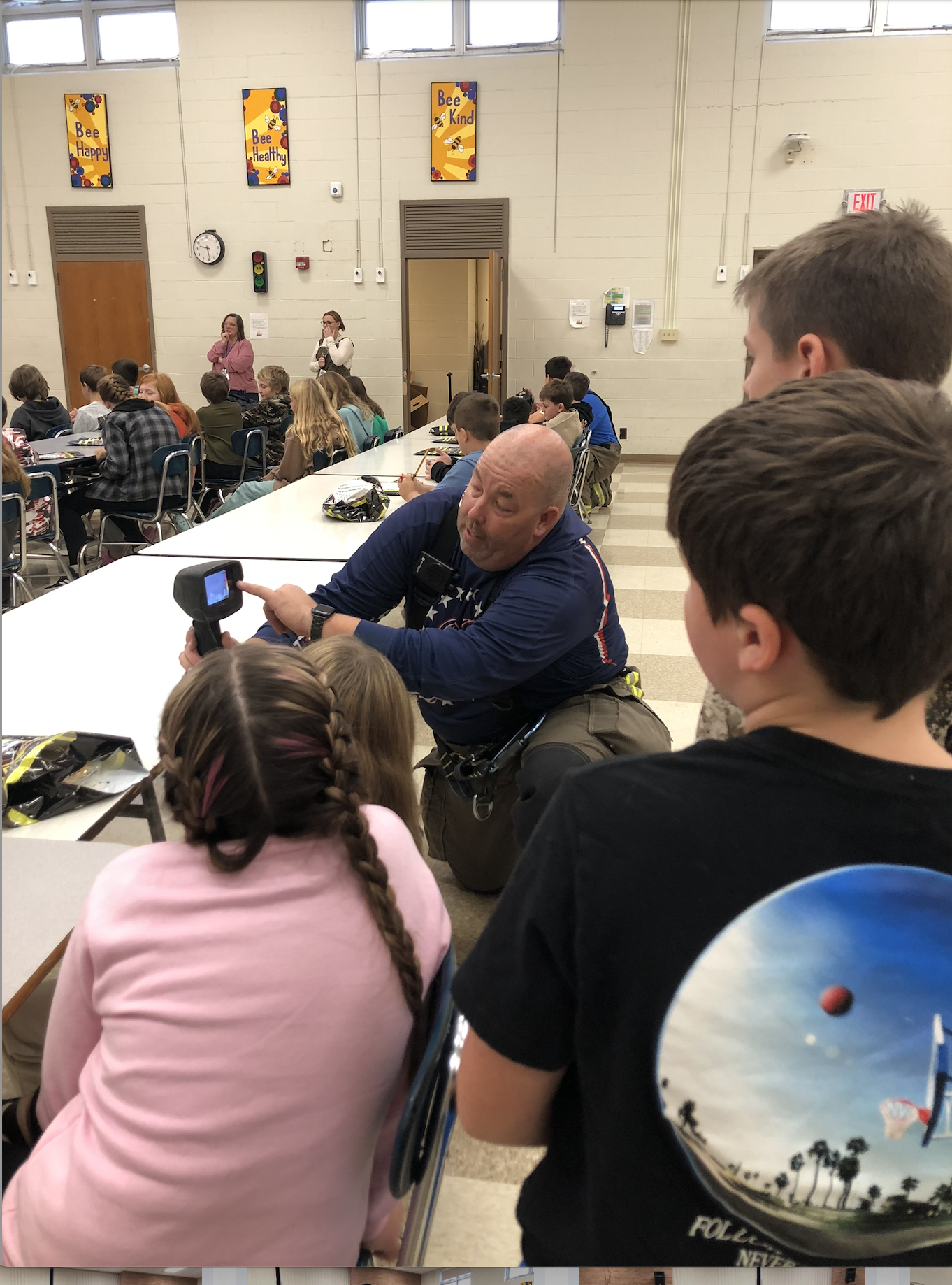 Fireman introduces fire department gear to students