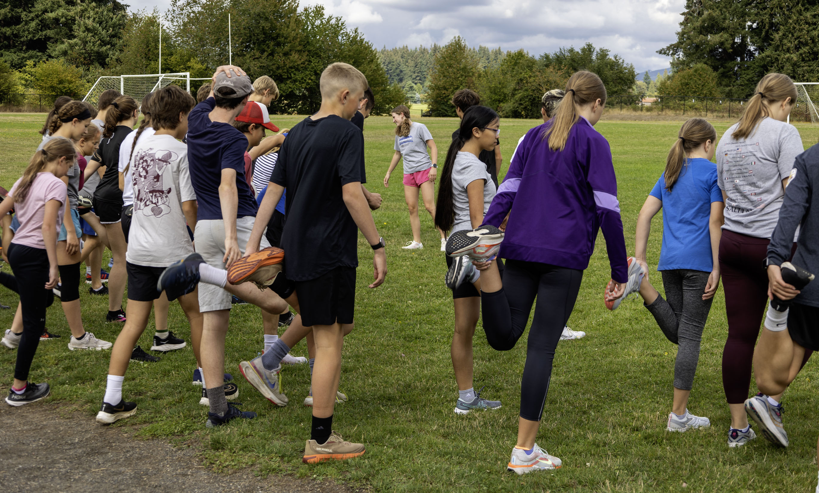 Middle school track athletes doing stretches