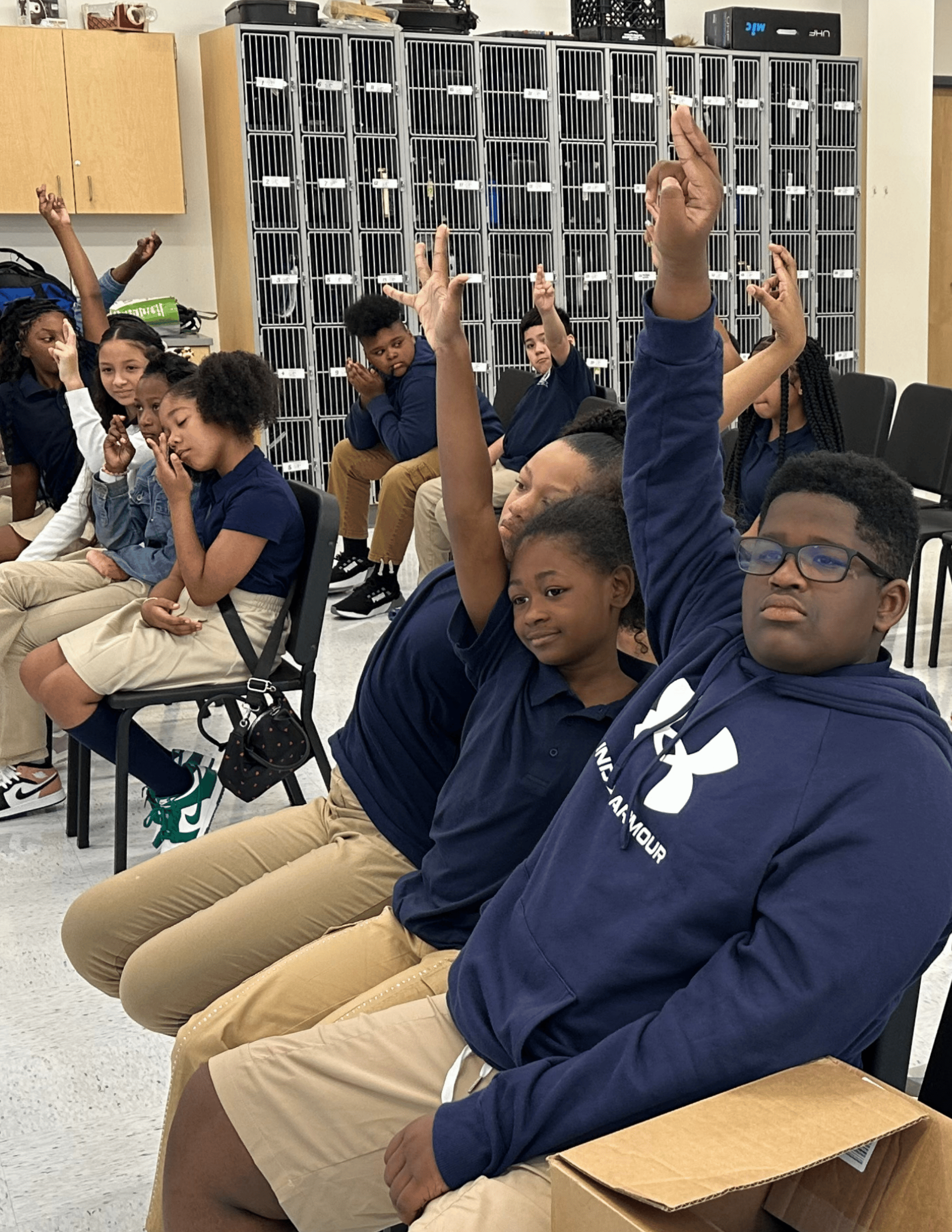 Students raising their hands at Cross Country Elementary/Middle School