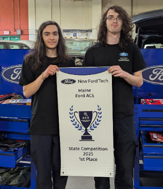 Two students holding award banner