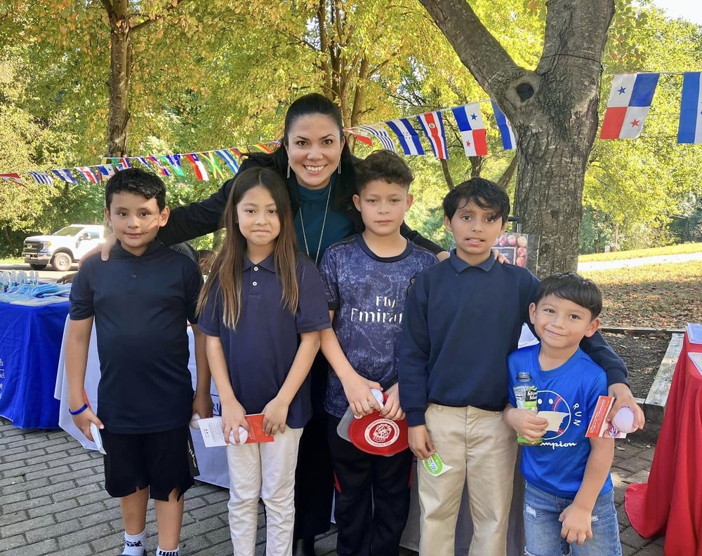 Frances Cruz-Serrano, shown with five school children