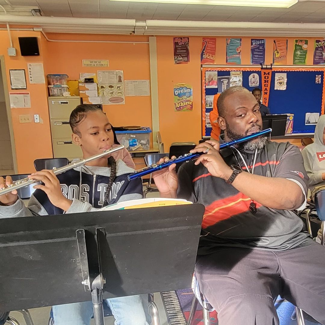 student playing flute with teacher 