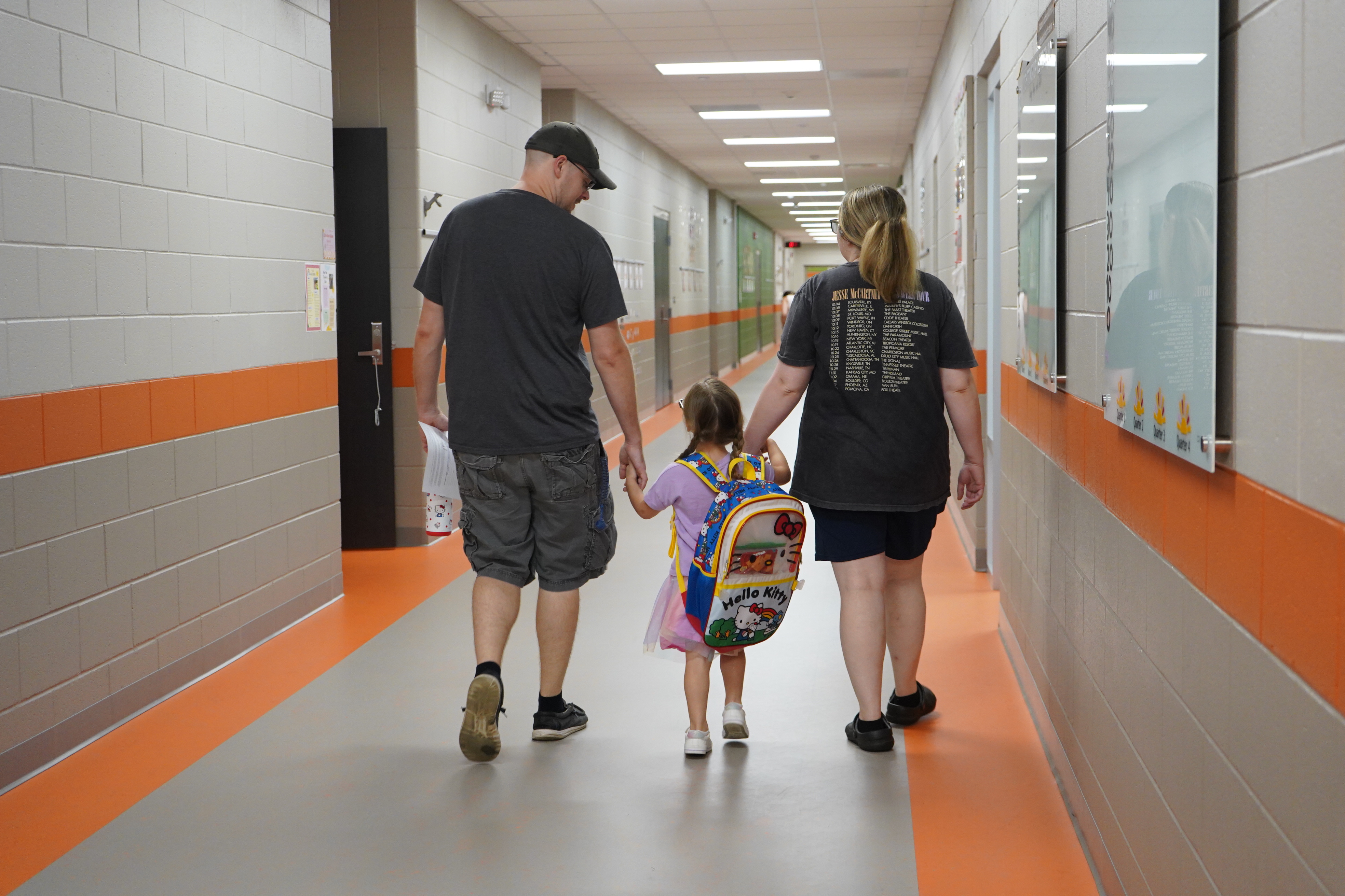 Parents walking student into school