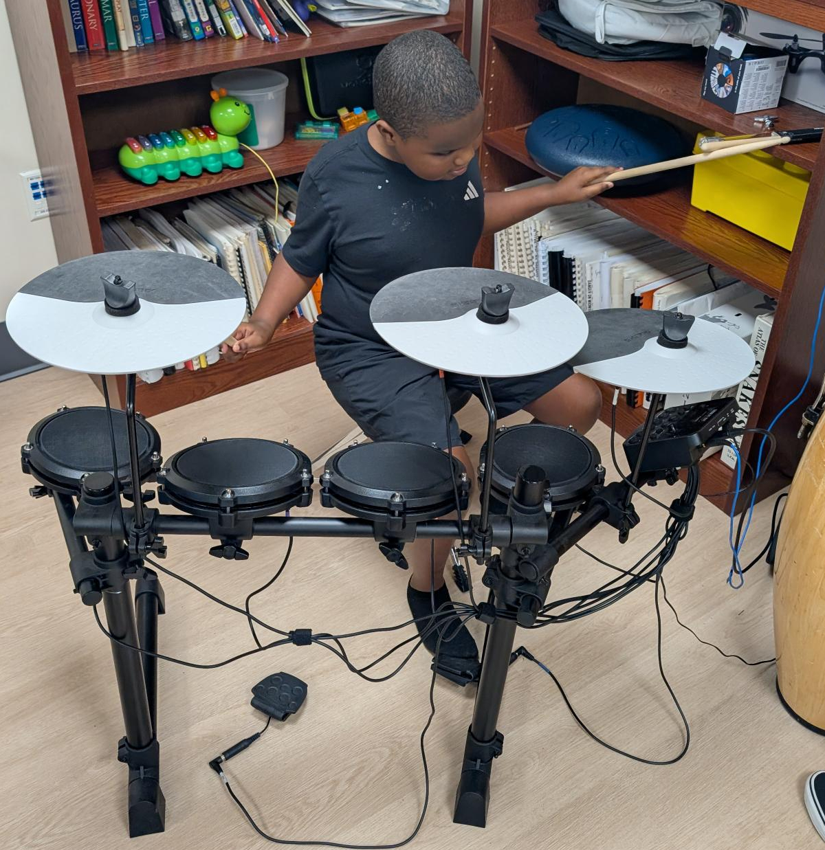 Zaiden playing the electric drums.