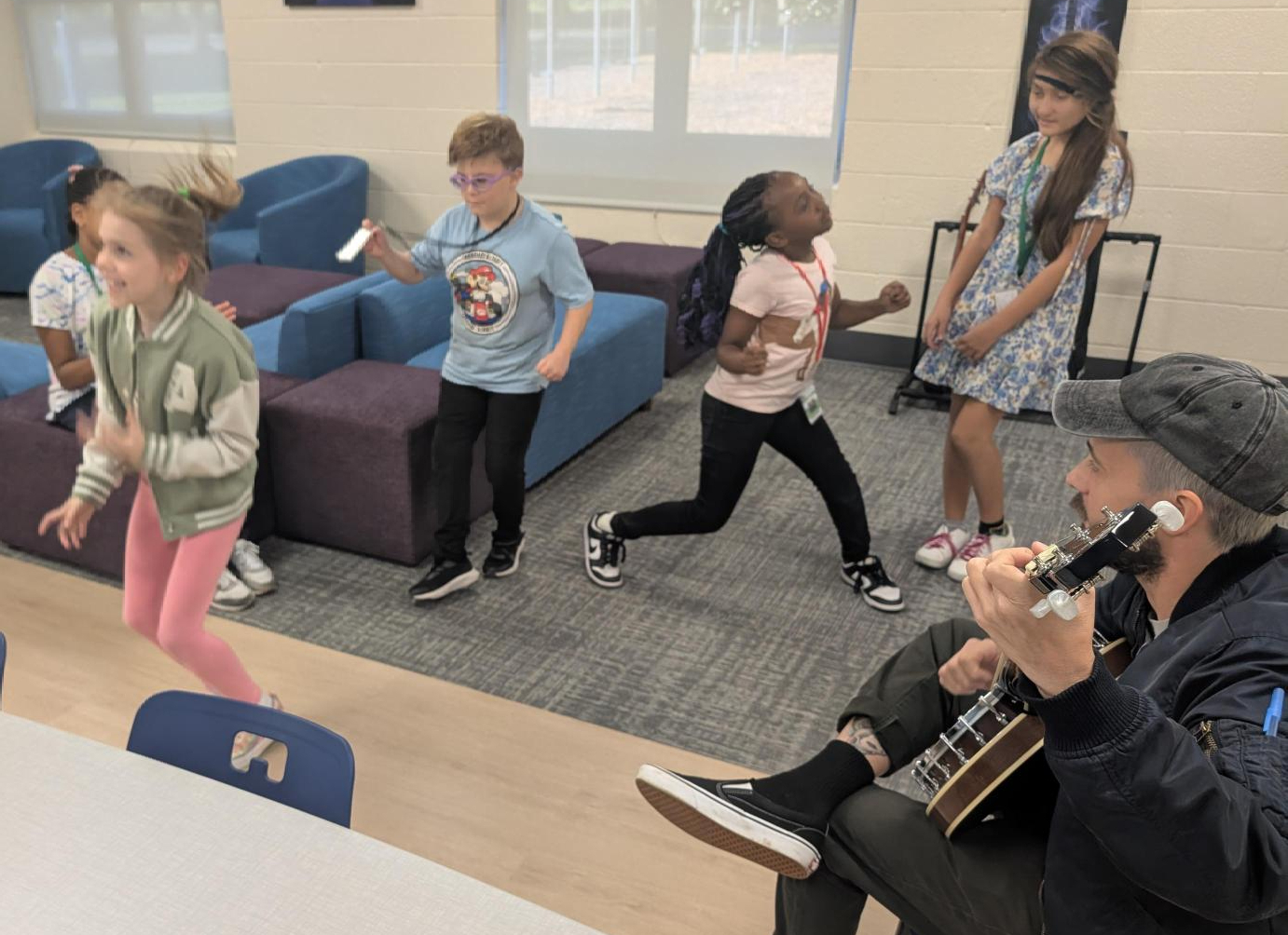 Kramer students dance while the staff plays the banjo.