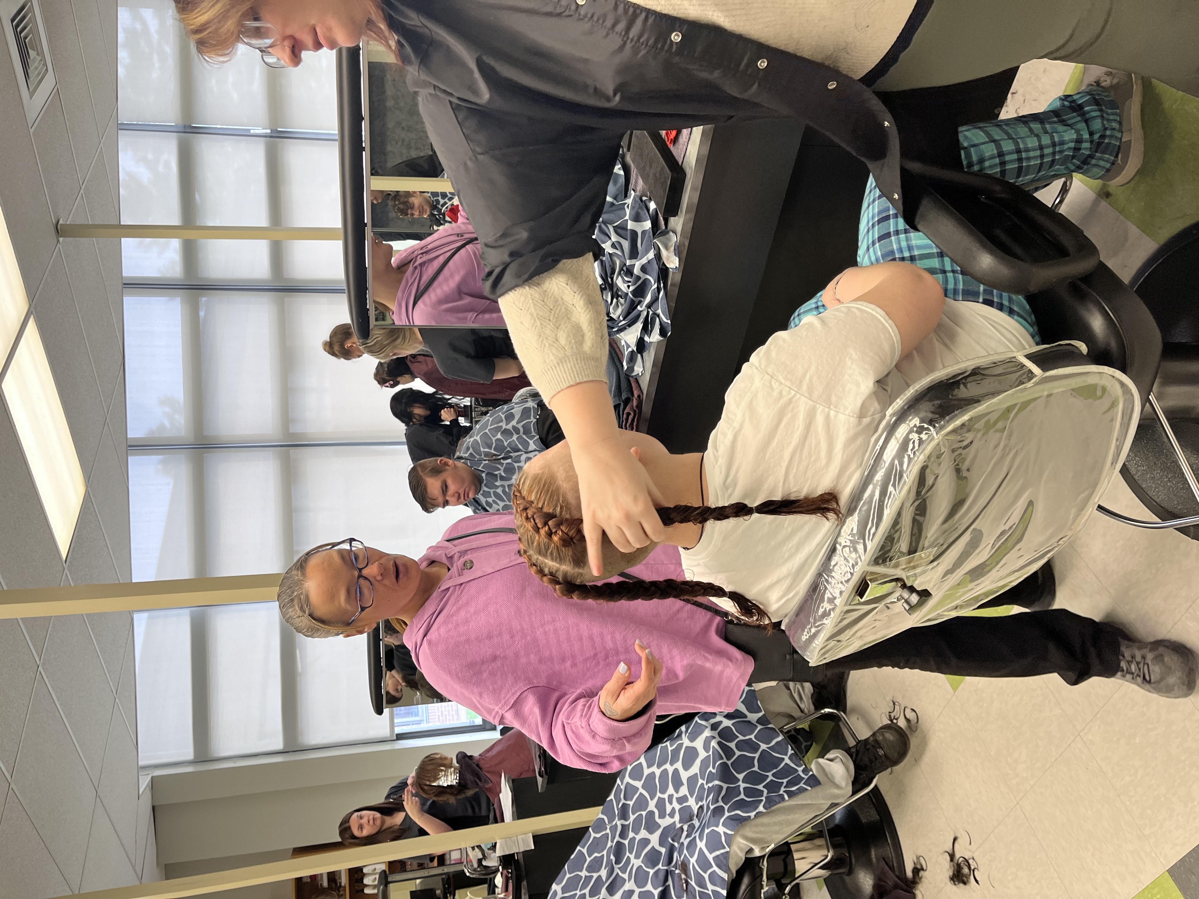 Student and teacher working on haircut for Pathways student