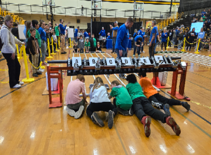 Students operate solar powered cars during a competition