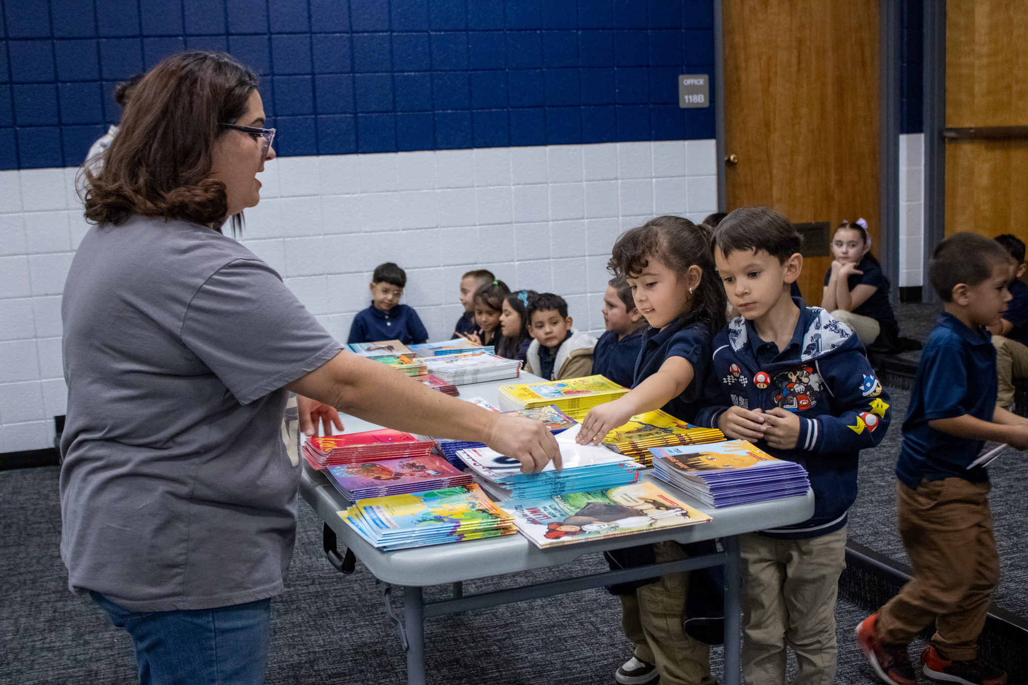 Students pick out three free books in the auditorium last week.  