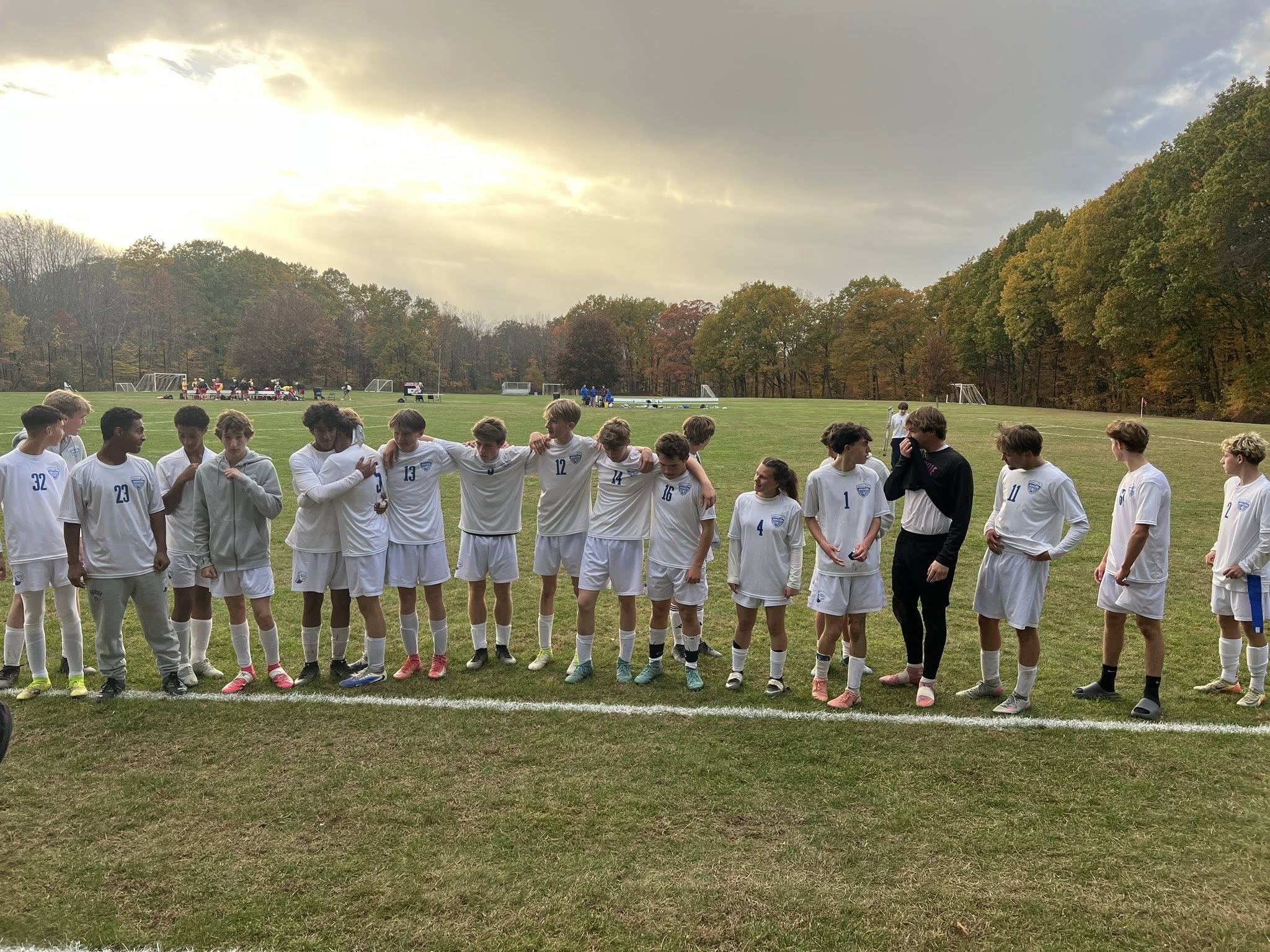 Varsity Soccer team, in white uniforms at Maple Valley
