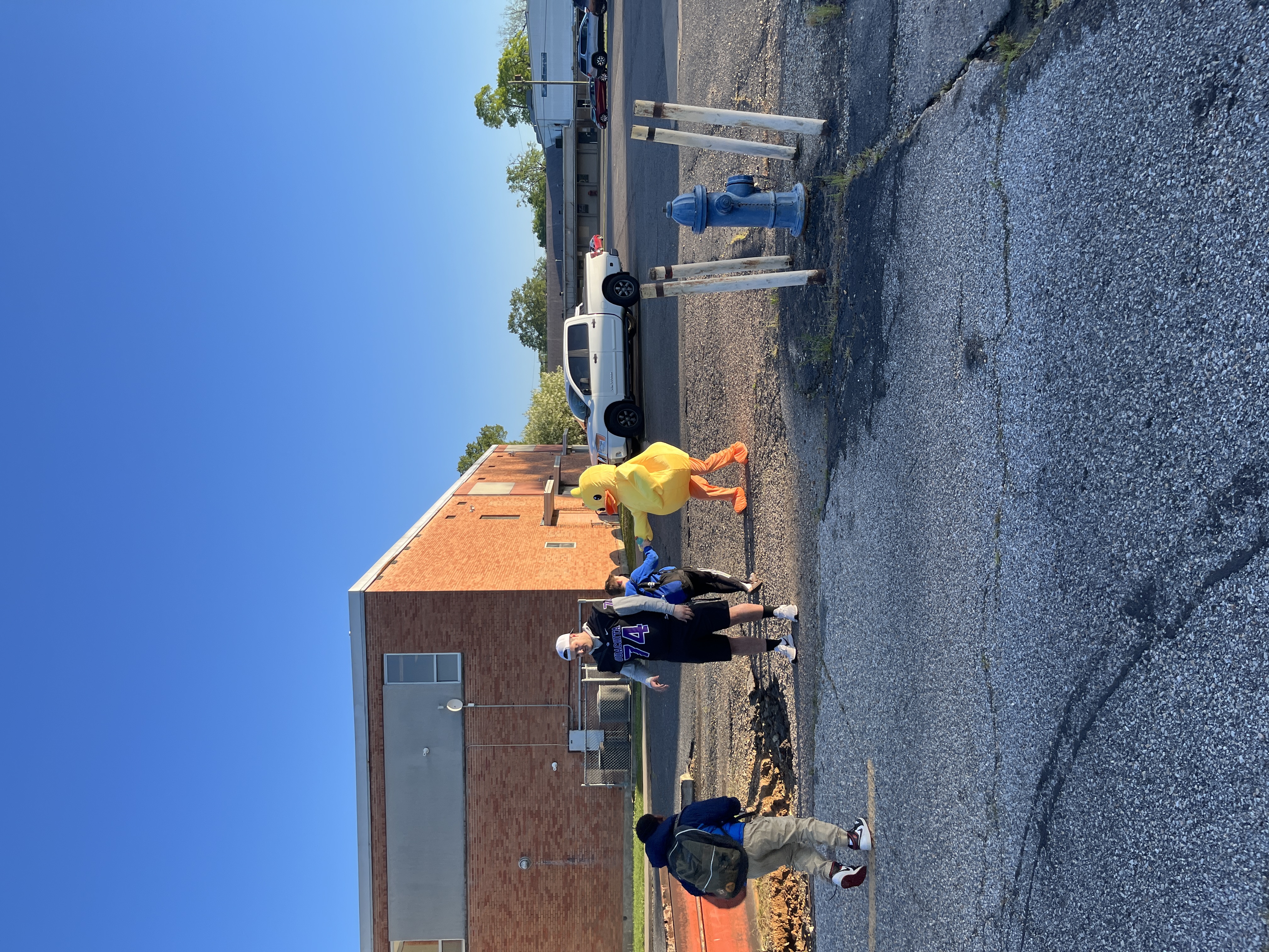 football player and duck greeting students