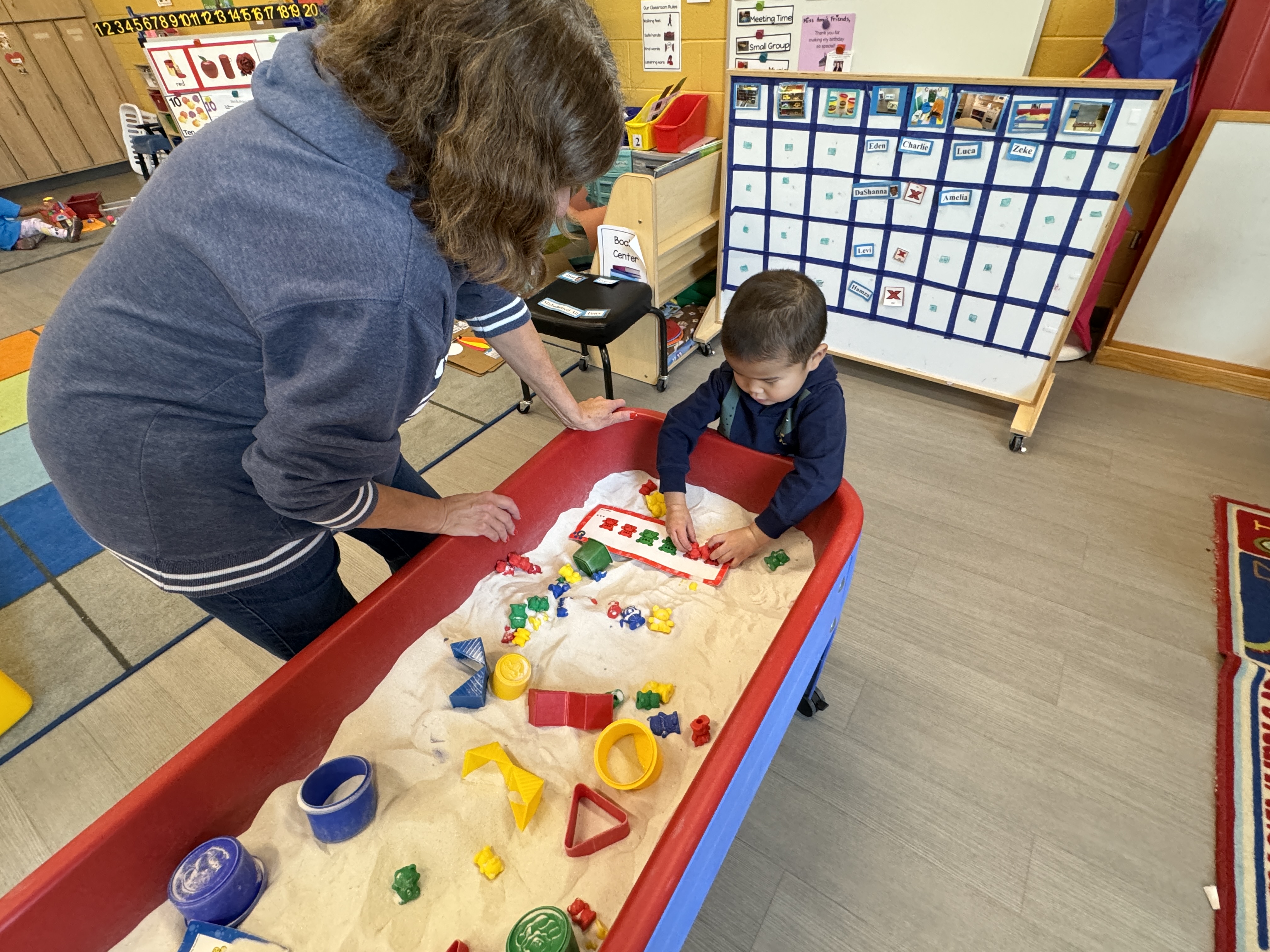 student playing in sensory bin