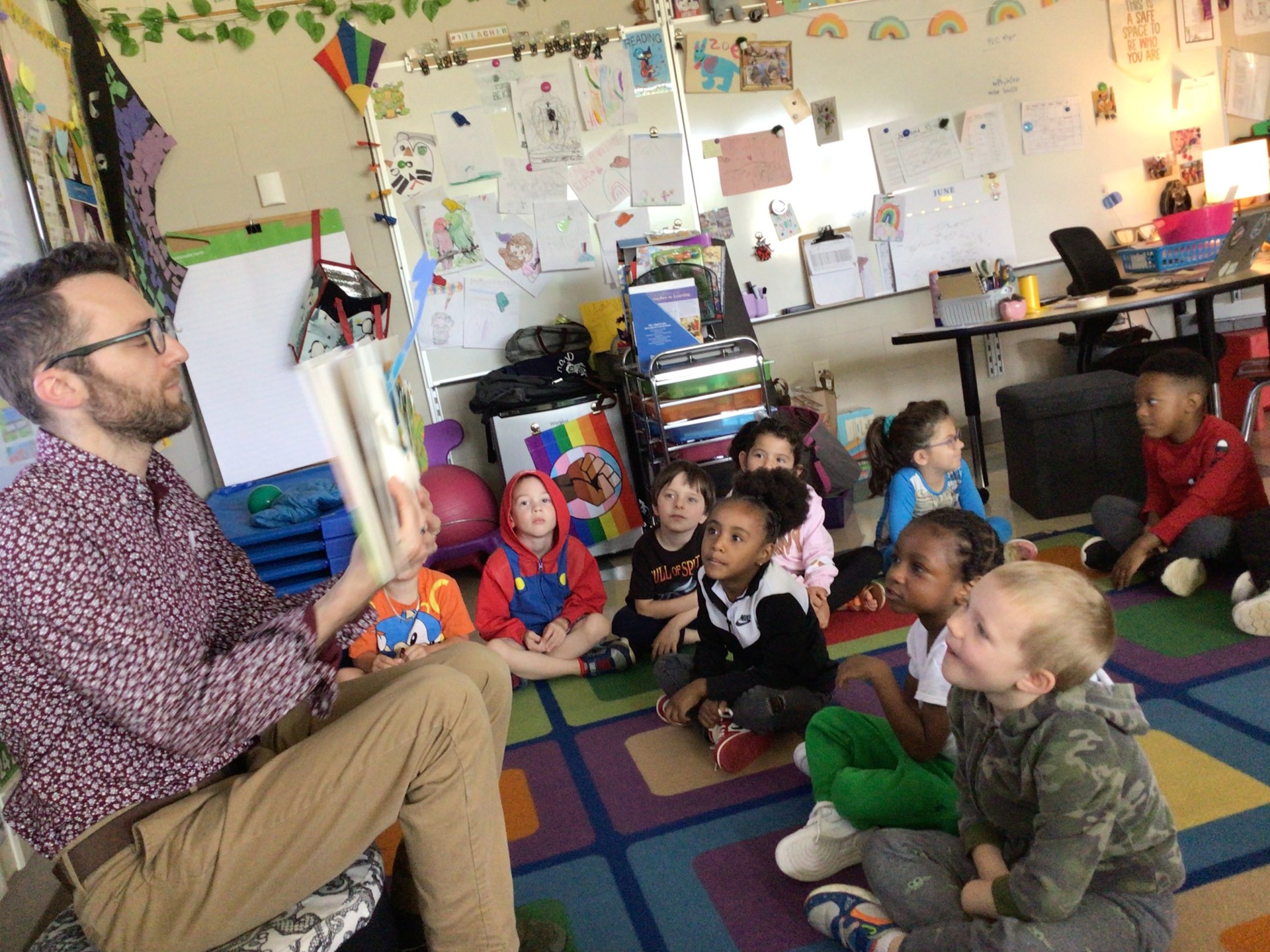 Teacher reading to students on carpet