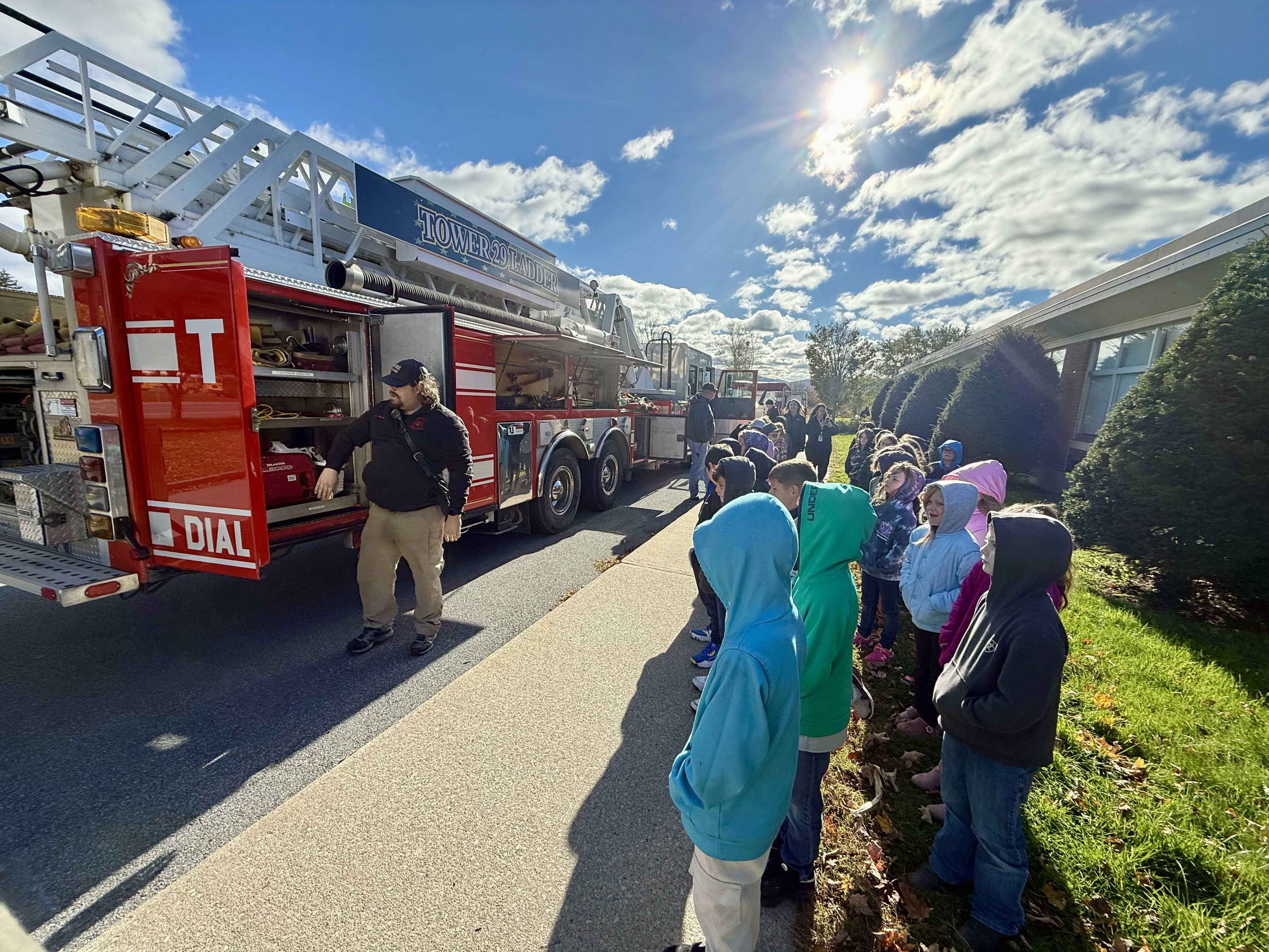 fire safety week - a fireman and their truck with MJT students watching a demonstration