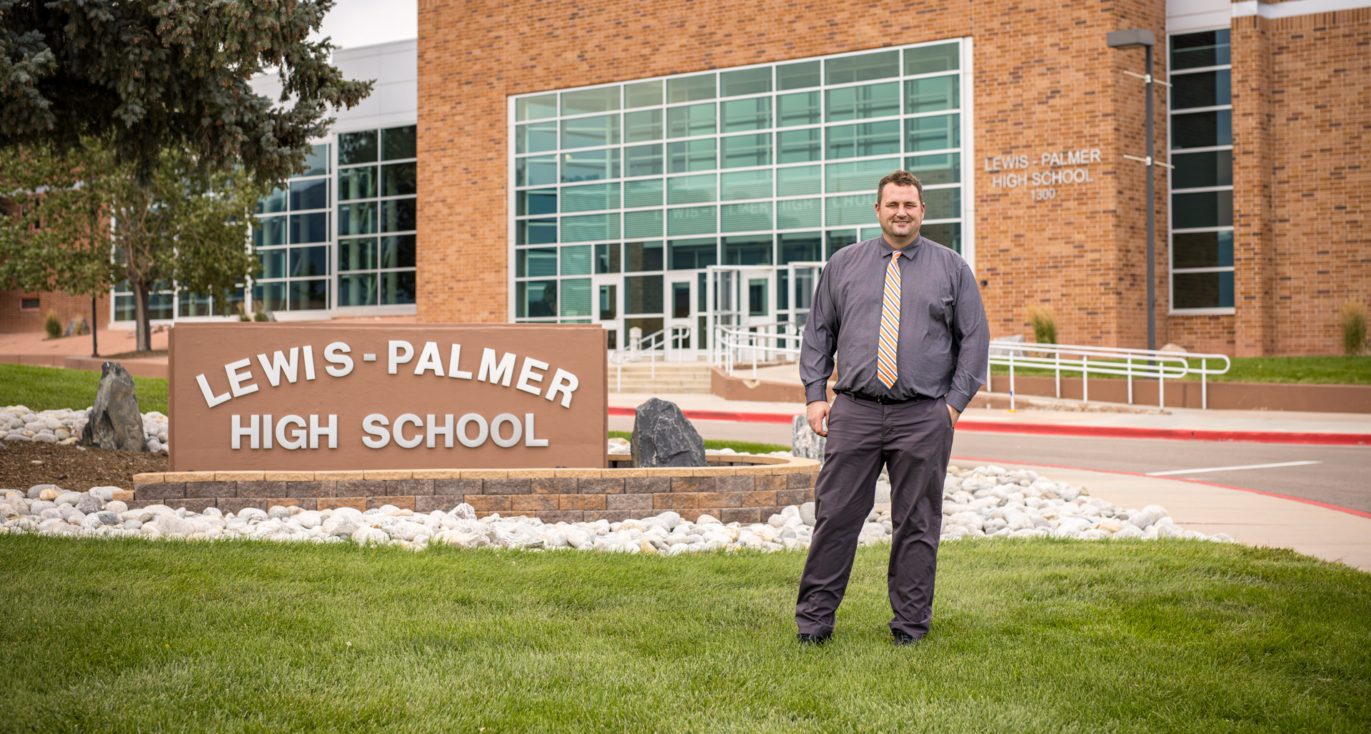 Principal Jeff Zick stading outside the entrance to Lewis-Palmer High School
