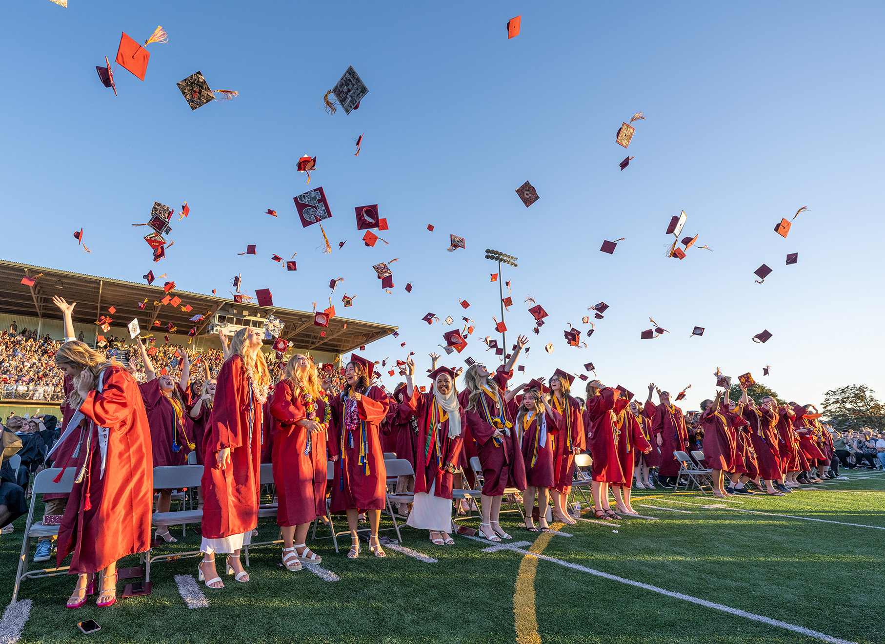Students throwing their mortarboards into the air during graduation