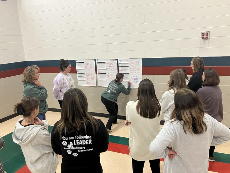 A team of teachers drawing out math problems