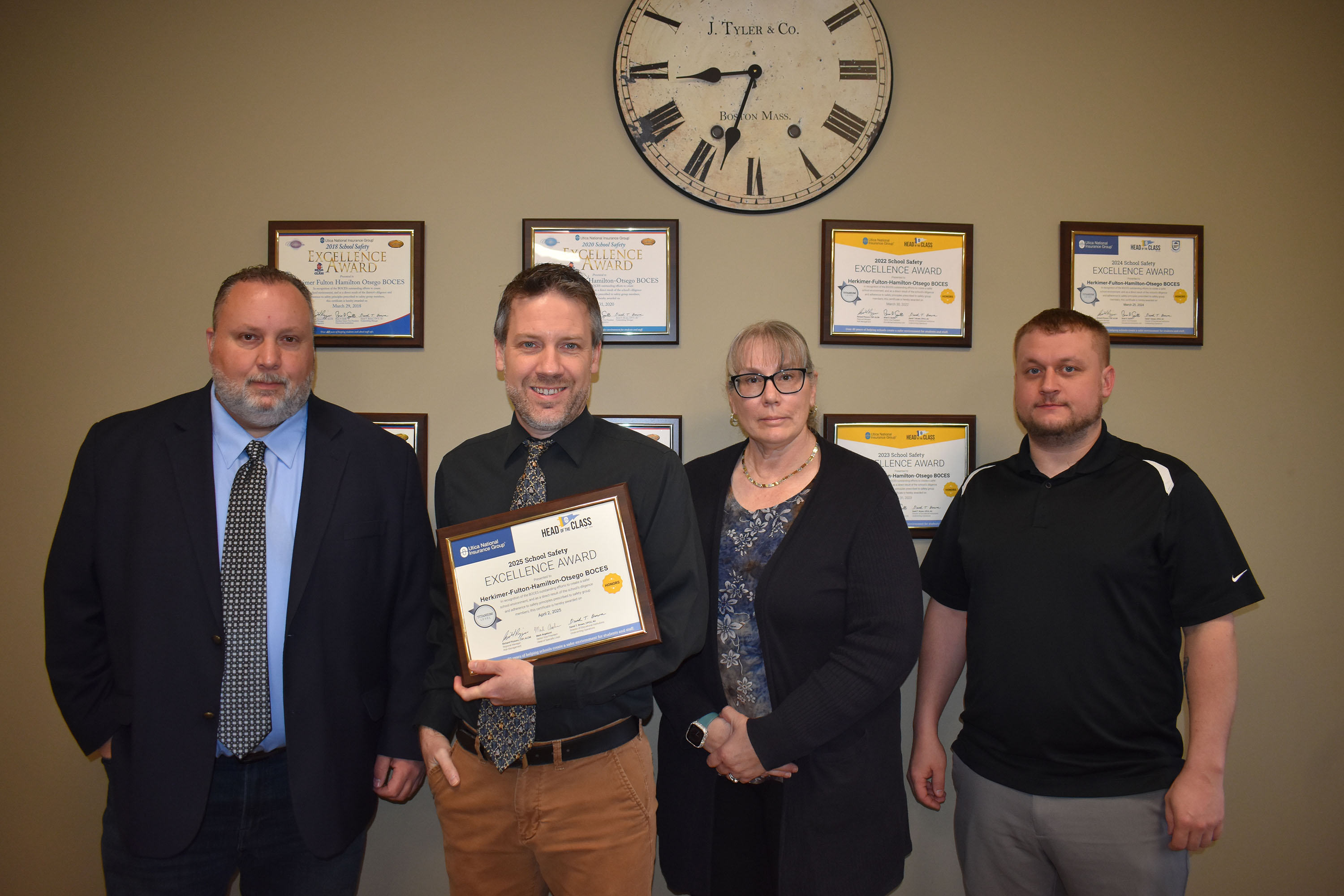 Four members of safety team with excellence award certificates
