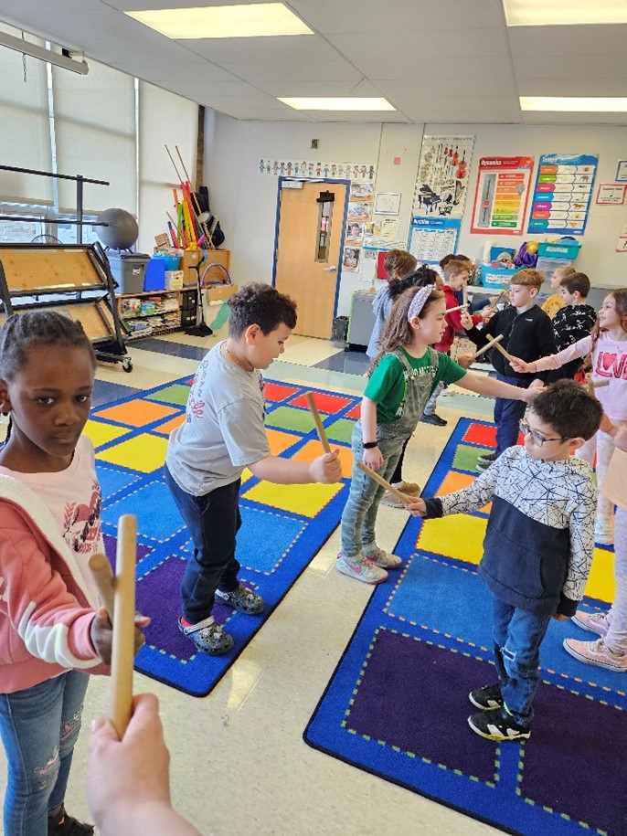 Students in music class,, using percussion instruments.