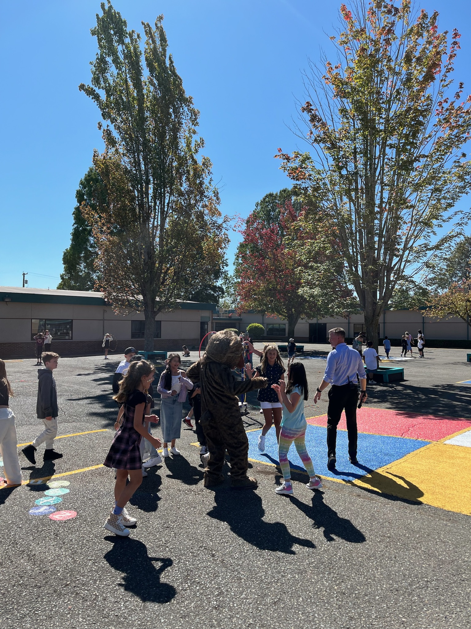 Kibler Bear mascot interacting with students 