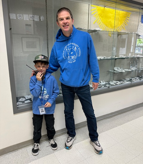 A student poses with a principal