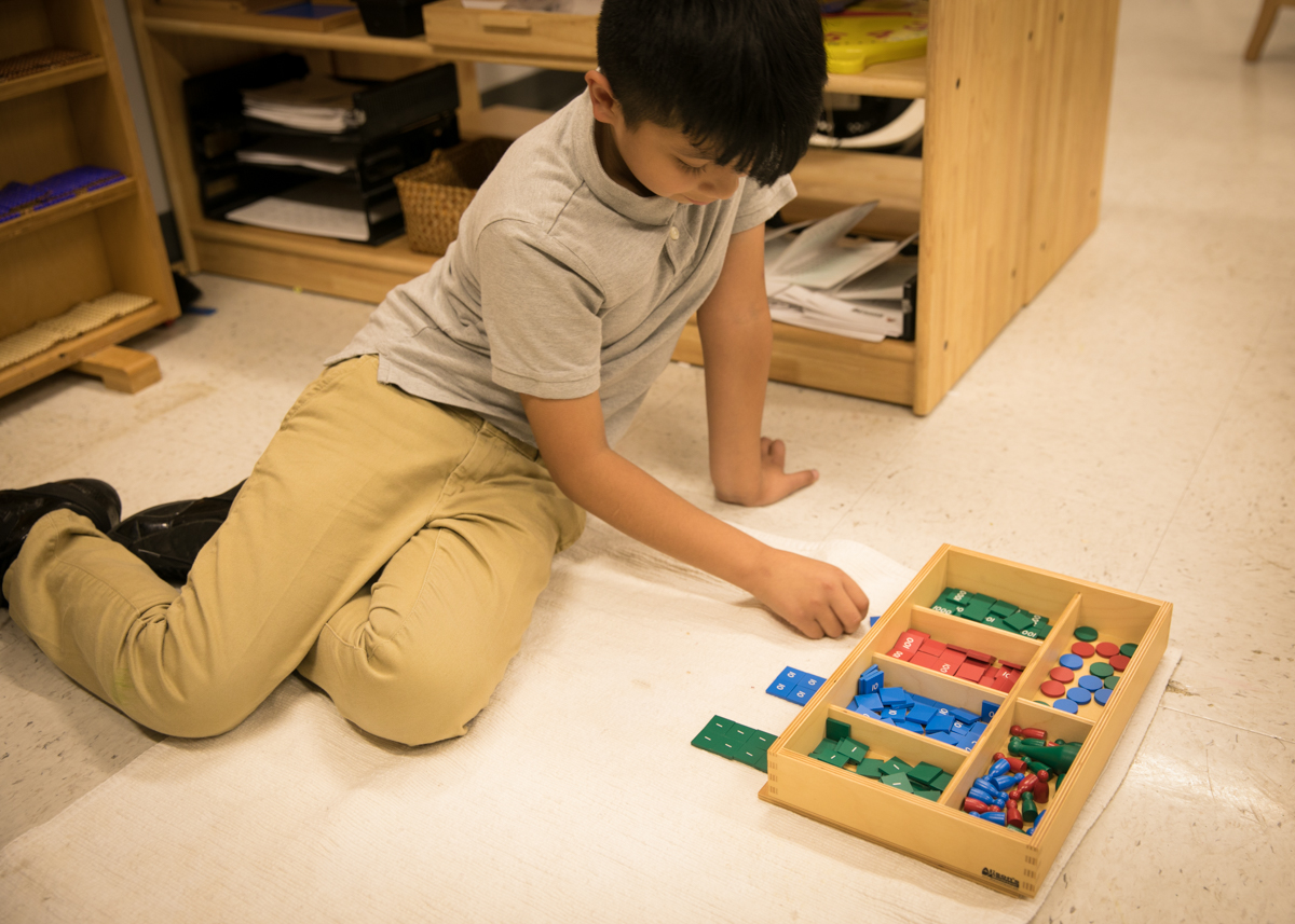 Student working with Montessori materials