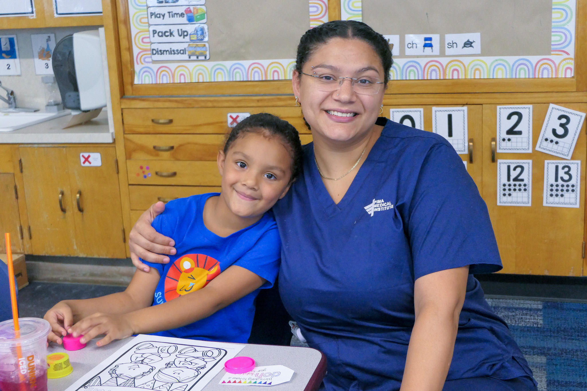 A student and their caregiver pose for a photo at the Back to School Open House