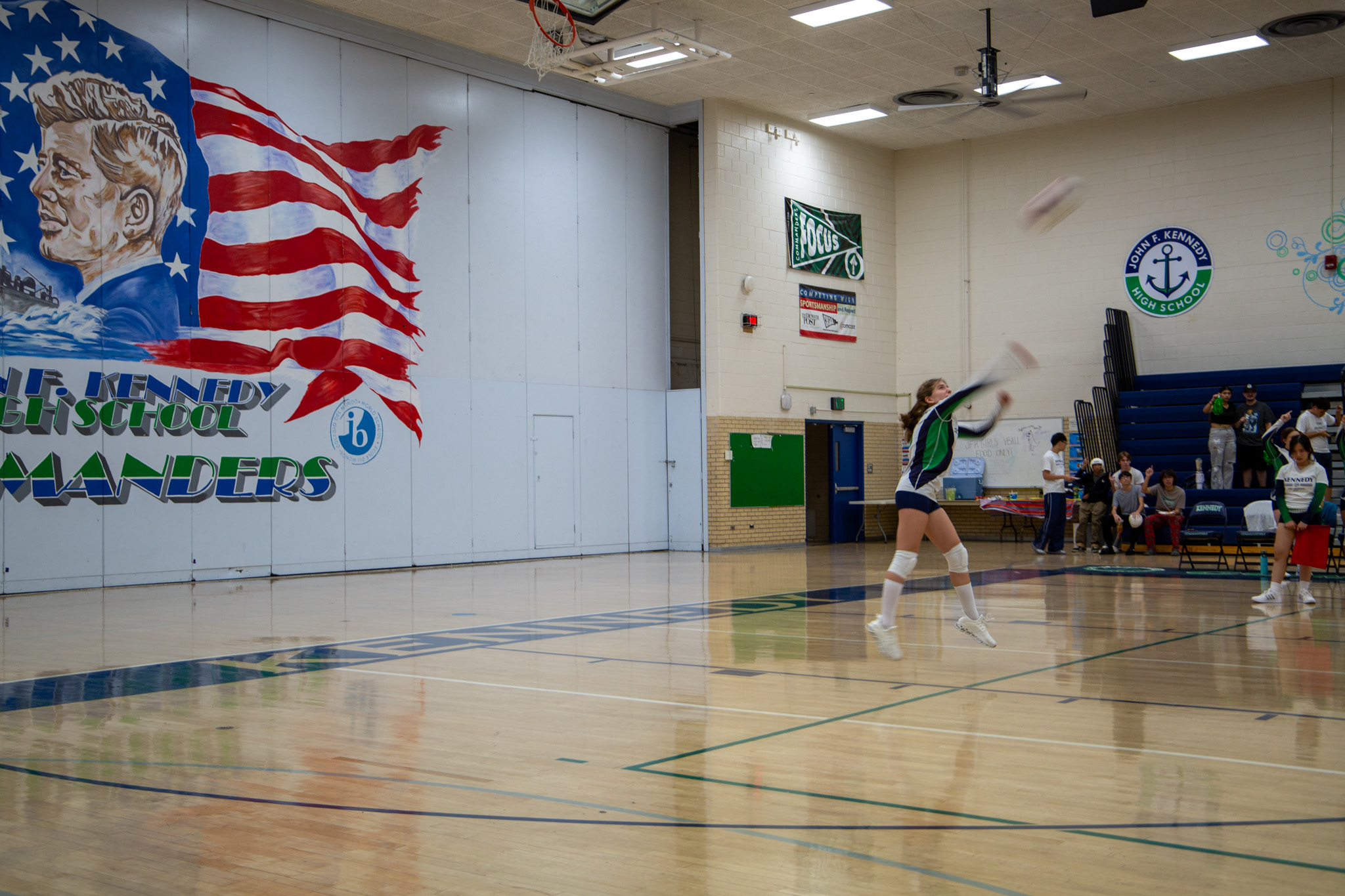 Pictured: A member of the JV volleyball team serves the ball at a home game. 