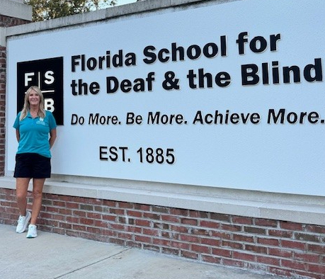 Ms. Tara standing in front of the FSDB sign