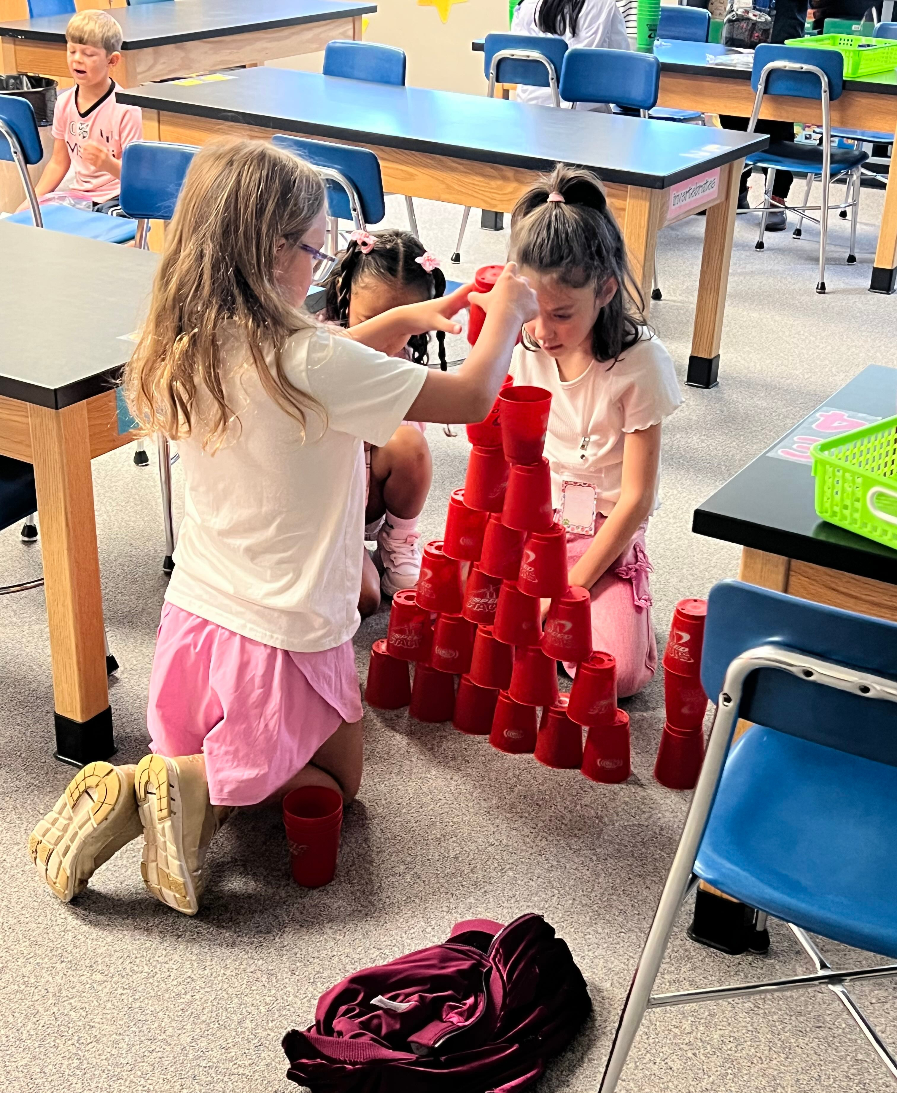 Students stacking cups