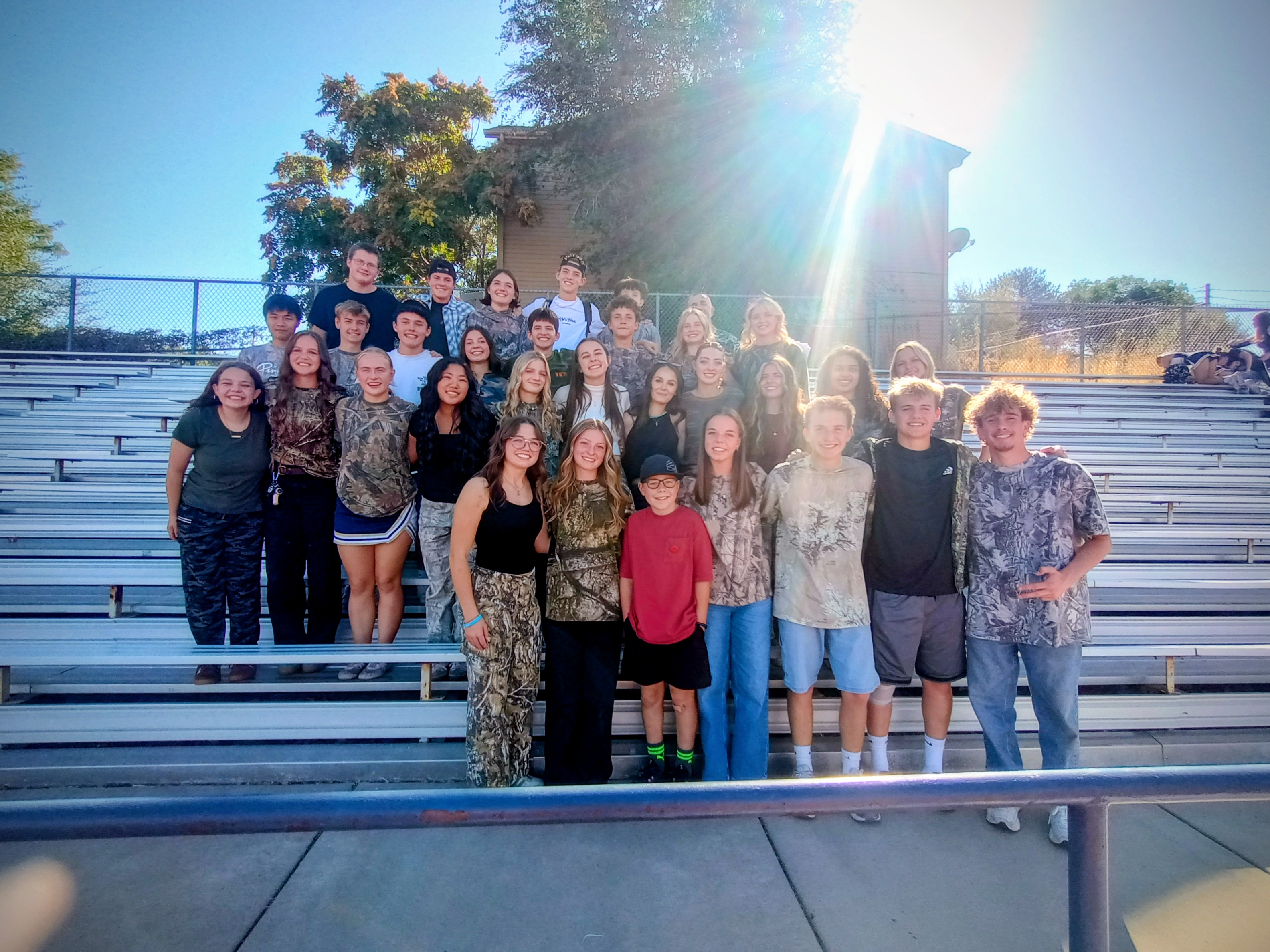 Students standing on football bleachers
