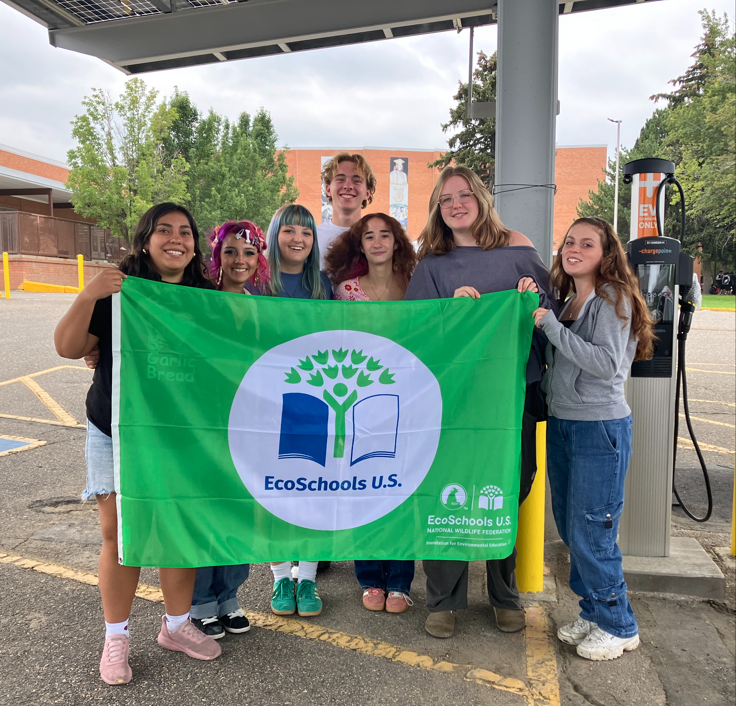 Students at TJ holding their NWF green flag