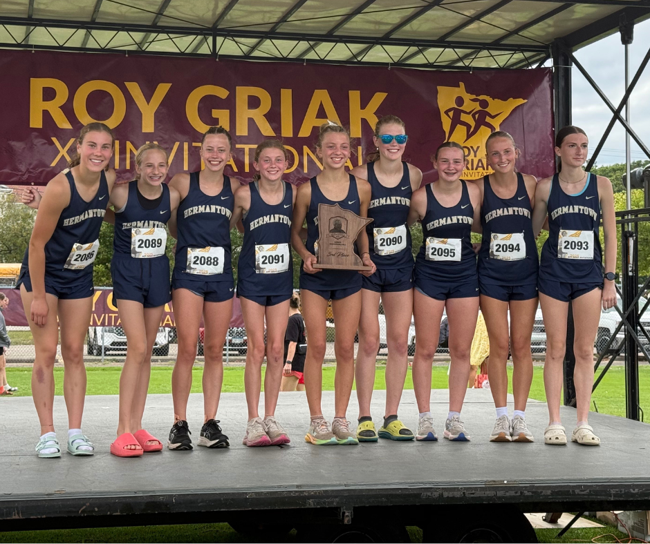 girls cross country runners holding their awards