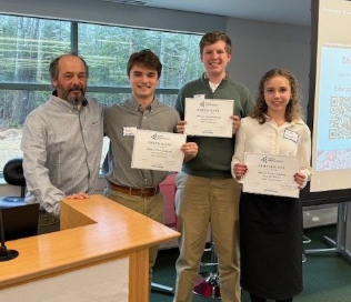 Teacher and three students holding certificates