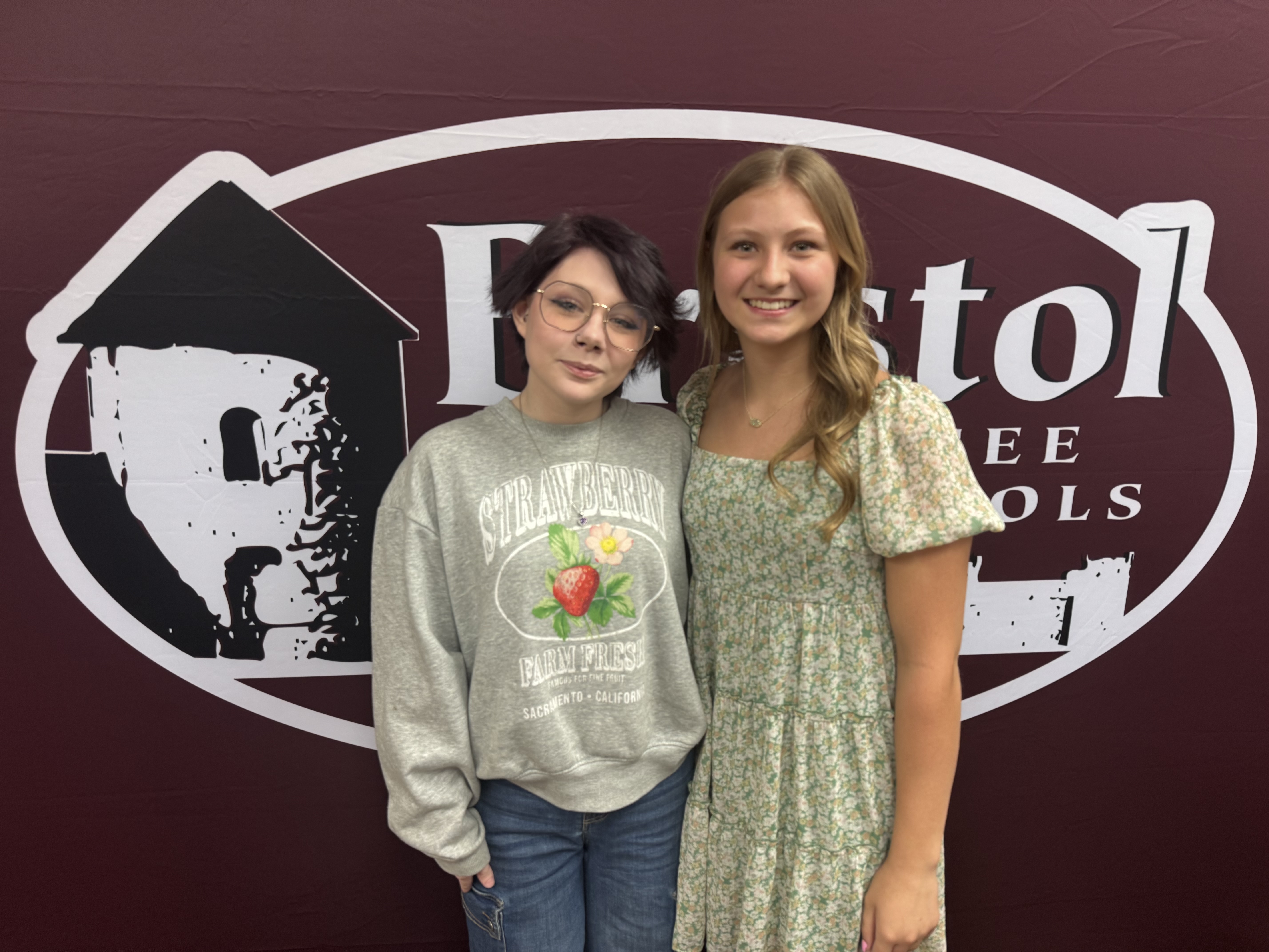 Tennessee High Students Taylor Greenway and Charlotte Osborne pictured in front of a backdrop of the Bristol Tennessee City Schools logo