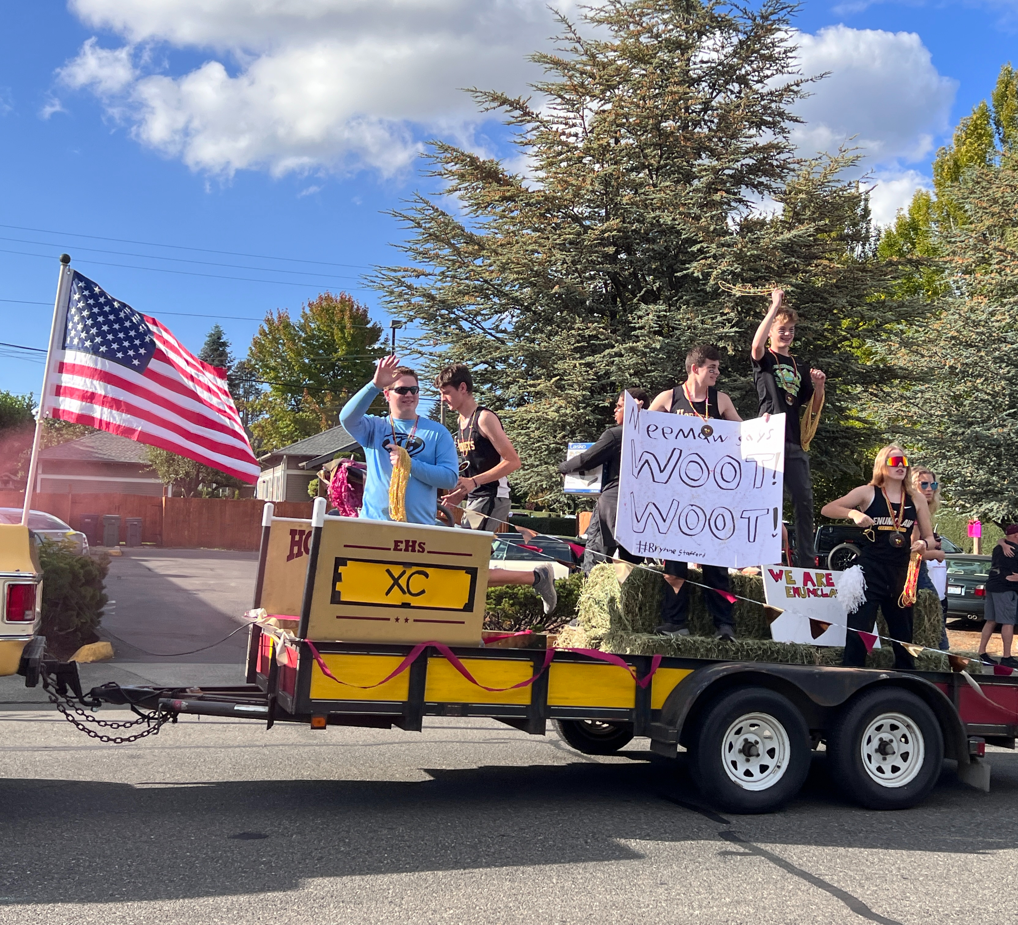 Students waving at crowd in parade