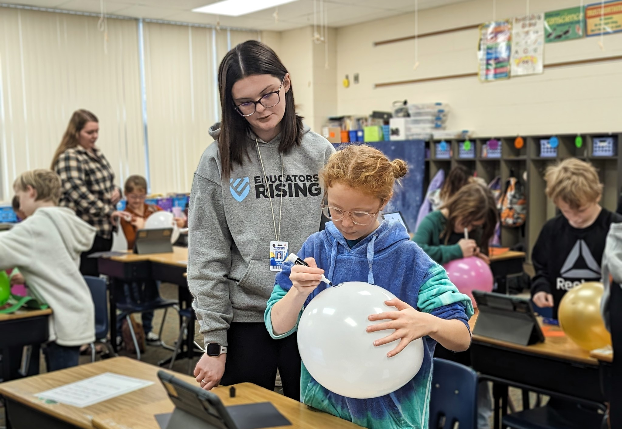 Educators Rising student helping in an elementary classroom