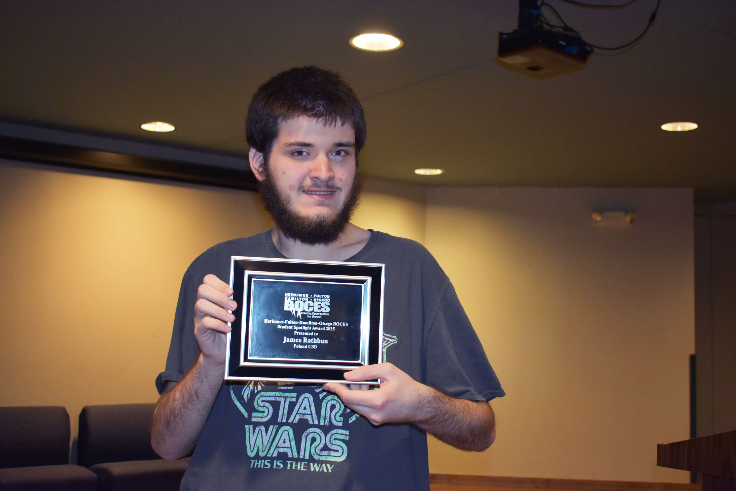 Student Spotlight Award winner holding plaque
