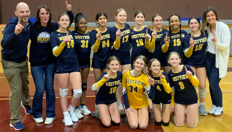 Volley ball team holding up number 1
