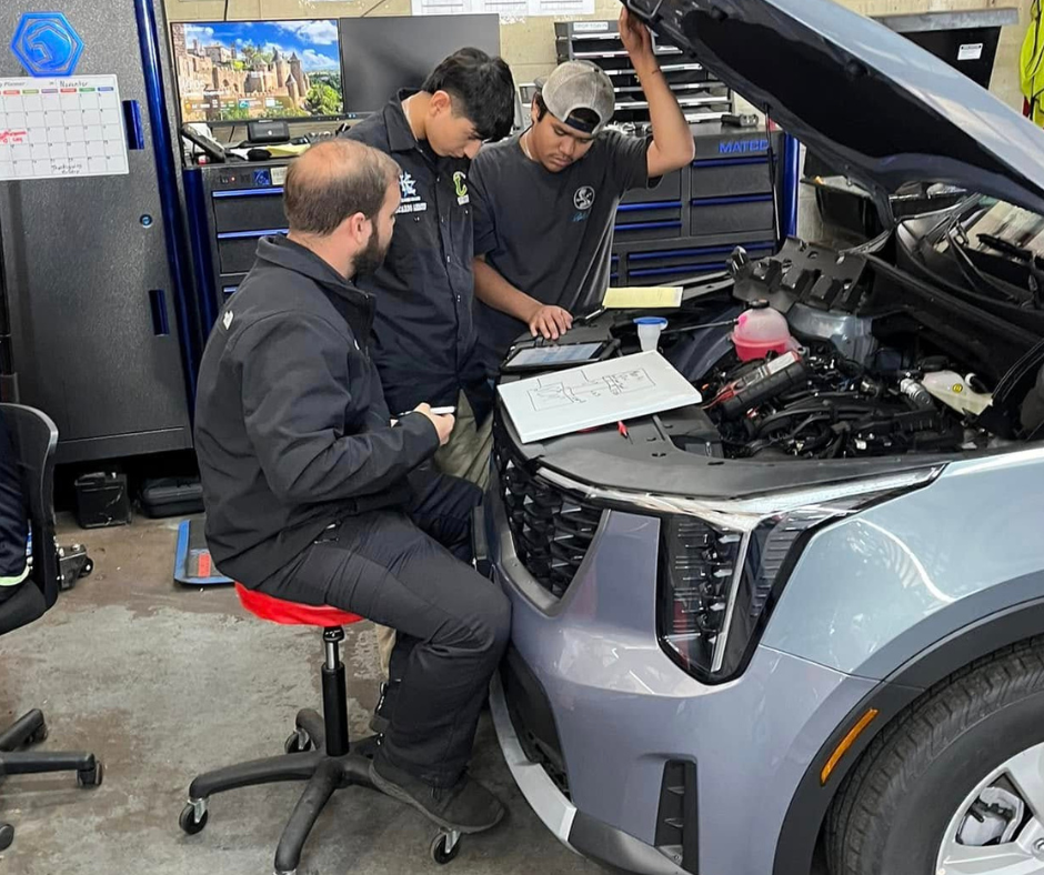 Two Lobo automotive students get hands-on experience at Peltier KIA.