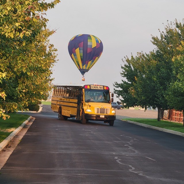 Balloon Hovering over Bus