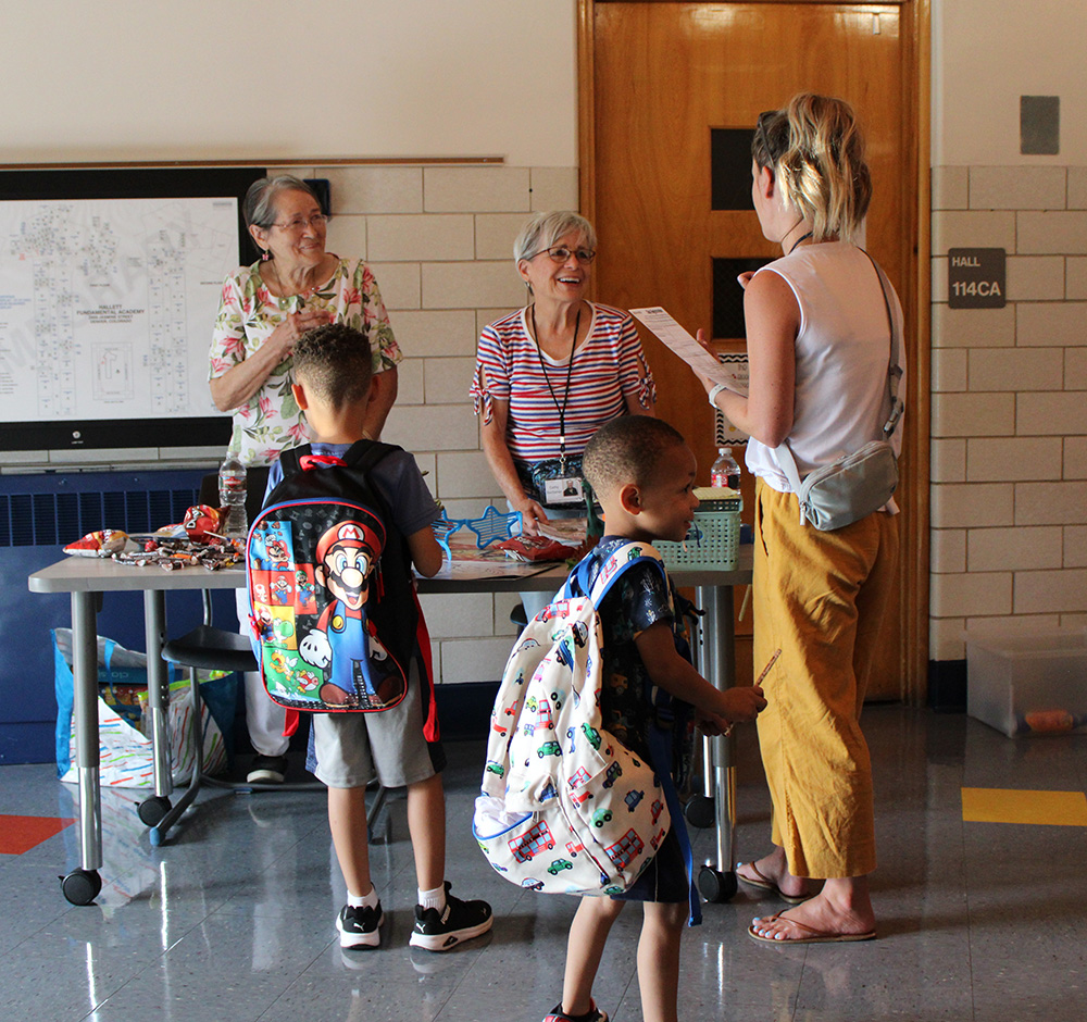 Students, parents and staff talking at a school